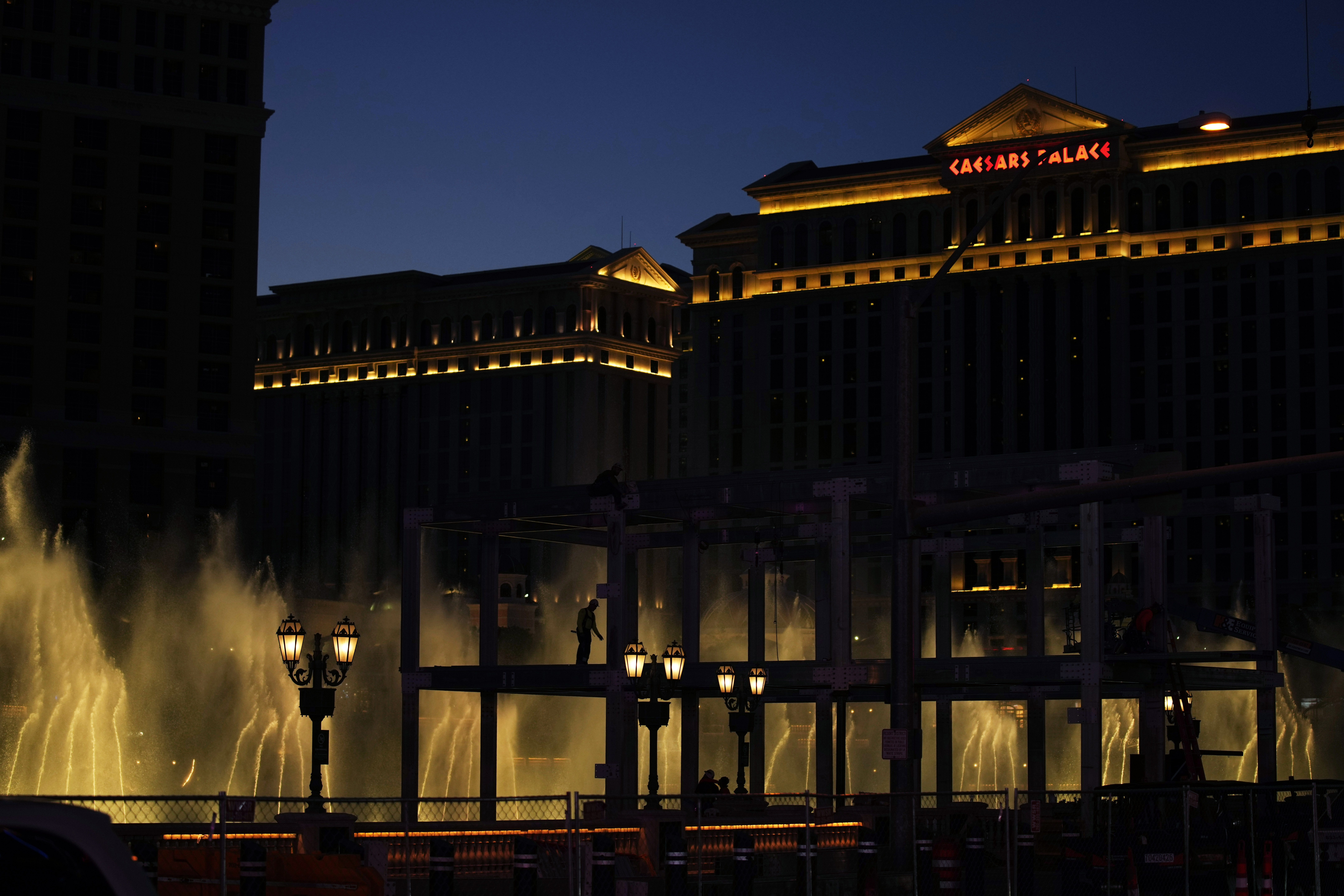Construction workers build a grandstand in front of the fountains at Bellagio hotel-casino along the Las Vegas Strip ahead of the Las Vegas Formula One Grand Prix auto race Tuesday, Sept. 19, 2023, in Las Vegas. 