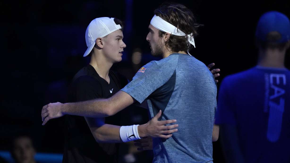 Greece's Stefanos Tsitsipas, right, embraces Denmark's Holger Rune after injuring during the singles tennis match of the ATP World Tour Finals at the Pala Alpitour, in Turin, Italy, Tuesday, Nov. 14, 2023.