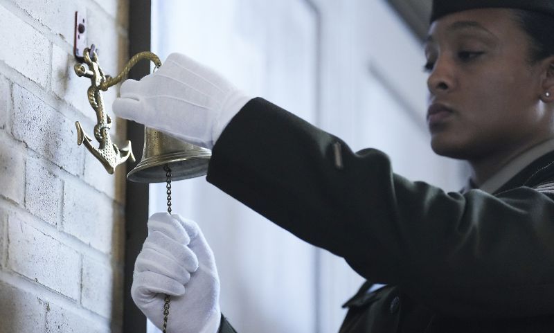 Sgt. Gabriela Corbalan rings a bell as the names of the soldiers from the 3rd Battalion, 24th Infantry Regiment, are read during an event at the Buffalo Soldiers Museum, Monday, in Houston. U.S. Army officials say they will overturn the convictions of over 100 Black soldiers accused of a mutiny at a Houston military camp a century ago in a trial that had racial undertones. 