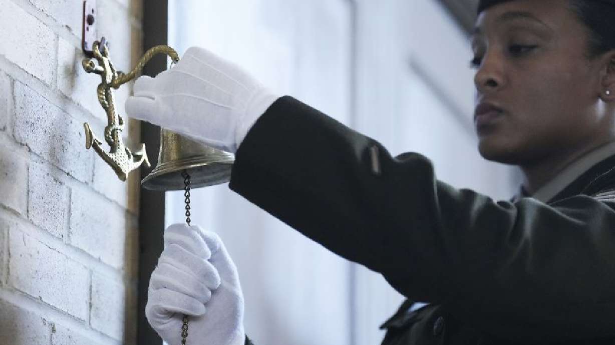 Sgt. Gabriela Corbalan rings a bell as the names of the soldiers from the 3rd Battalion, 24th Infantry Regiment, are read during an event at the Buffalo Soldiers Museum, Monday, in Houston. U.S. Army officials say they will overturn the convictions of over 100 Black soldiers accused of a mutiny at a Houston military camp a century ago in a trial that had racial undertones.