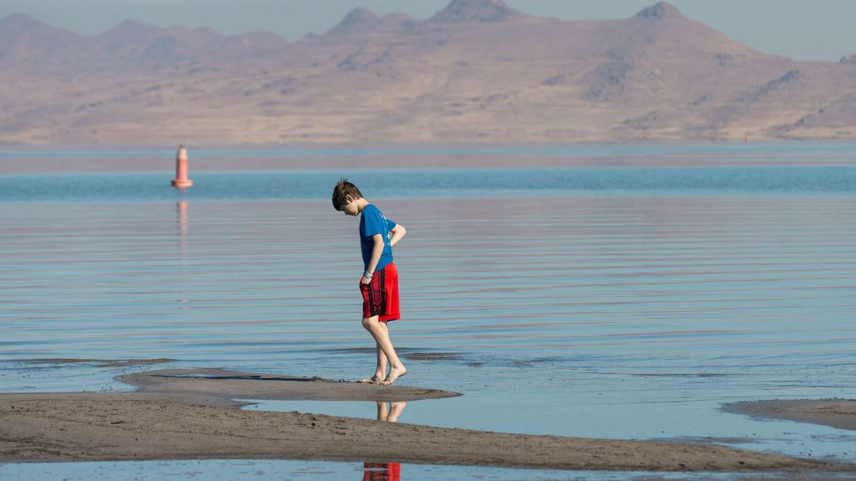 Isaiah Ingersoll walks on the beach at Great Salt Lake State Park in Magna on Oct. 6. State officials say they are acquiring land now in Box Elder County to prepare for future water needs.