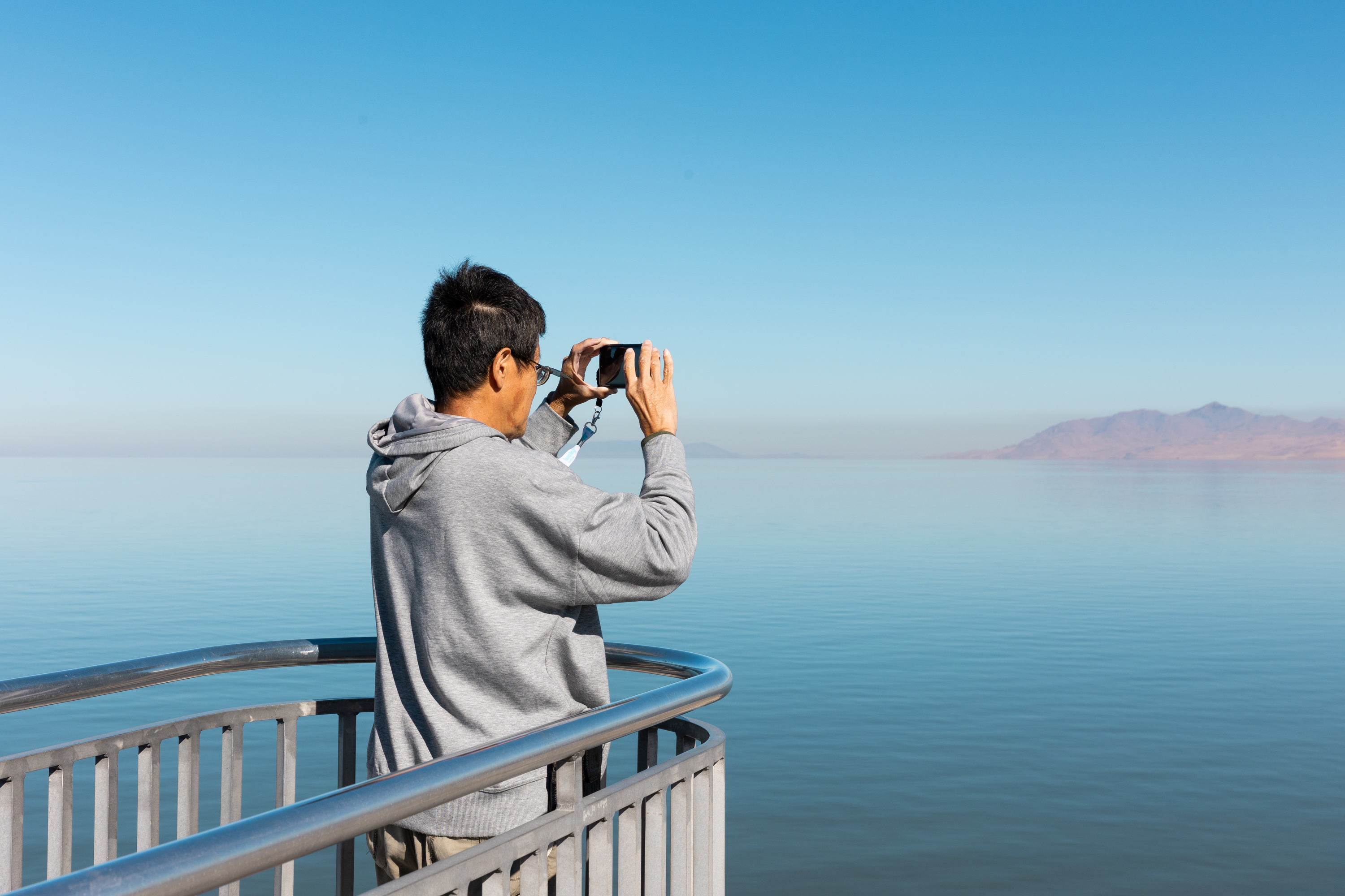 A tourist takes a photo at Great Salt Lake State Park in Magna on Oct. 6. Utah's Great Salt Lake commissioner said "longer-term" efforts to get water to the struggling lake are more realistic based on new data on how much water it still needs.