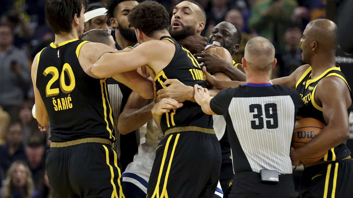 Golden State Warriors' Klay Thompson, front, and Draymond Green, back, get into an altercation with Minnesota Timberwolves center Rudy Gobert, middle, during the first half of an in-season NBA tournament basketball game in San Francisco, Tuesday, Nov. 14, 2023. All three were ejected.