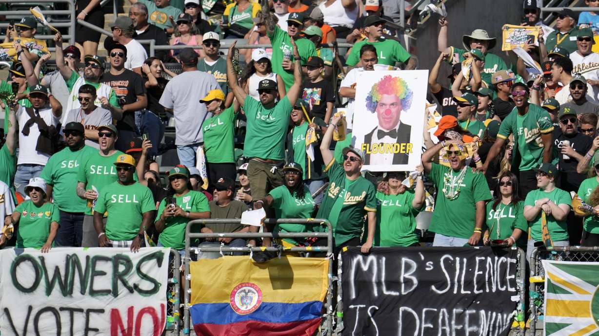 FILE - Oakland Athletics fans in right field yell behind signs protesting the team's potential move to Las Vegas and to call for managment to sell the team during the fifth inning of a baseball game between the Athletics and the San Francisco Giants in Oakland, Calif., Saturday, Aug. 5, 2023. Major League Baseball team owners are set to vote Thursday, Nov. 16, on the proposed relocation of the Oakland Athletics to Las Vegas at the end of their league-wide meeting.