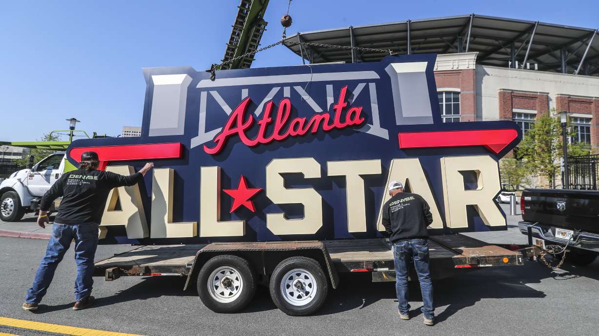 FILE - Workers load an All-Star sign onto a trailer after it was removed from Truist Park in Atlanta, Tuesday, April 6, 2021. Major League Baseball will play its 2025 All-Star Game in Atlanta, four years after moving the game from Truist Park to Denver’s Coors Field over objections to changes in Georgia’s votings rights laws. Baseball Commissioner Rob Manfred made the announcement Thursday, Nov. 16, 2023, following an owners’ meeting.