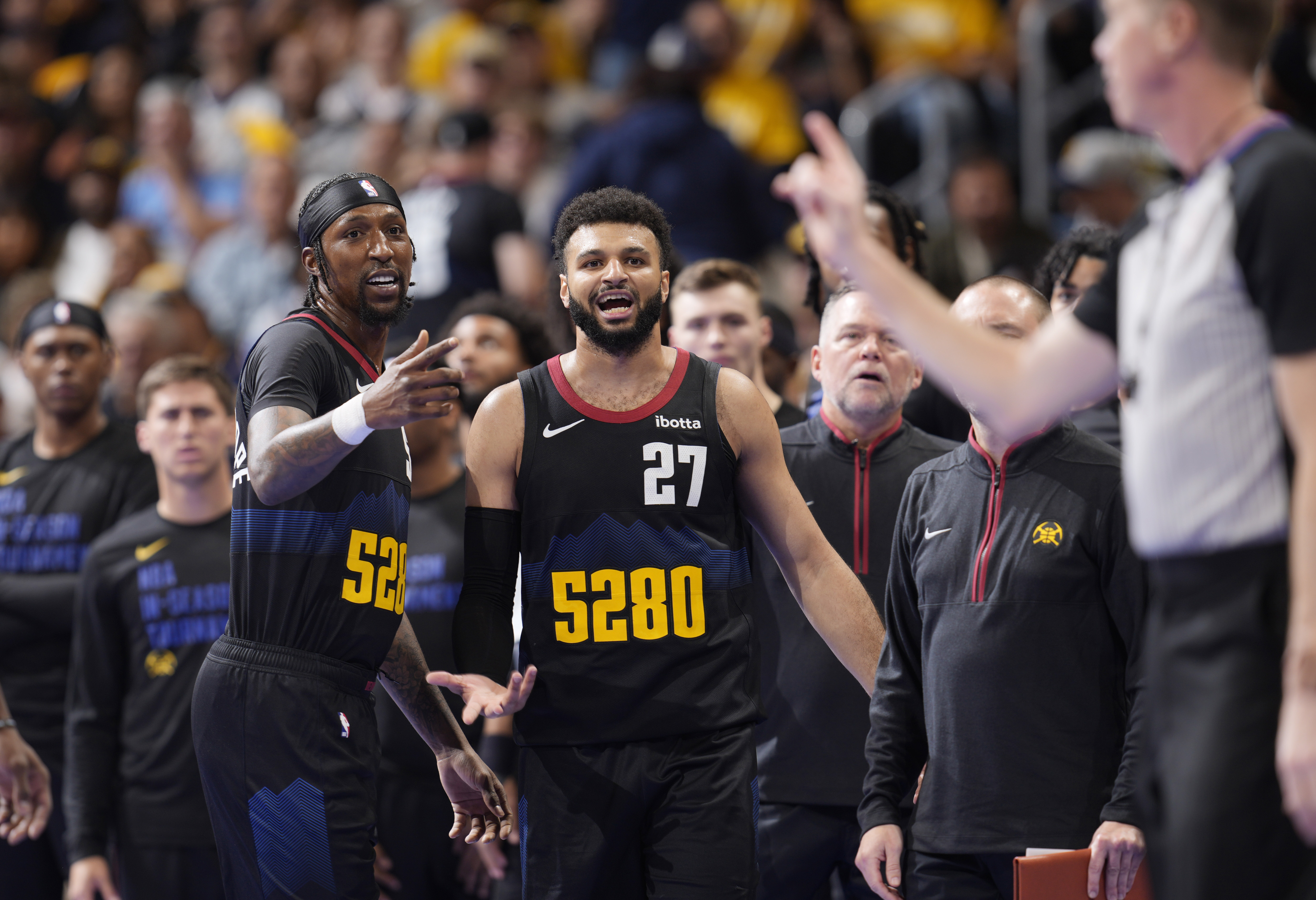 referee Ed Malloy, right, issues a technical foul on Denver Nuggets guard Jamal Murray (27), as guard Kentavious Caldwell-Pope gestures during the second half of the team's NBA basketball in-season tournament game against the Dallas Mavericks on Friday, Nov. 3, 2023, in Denver. 