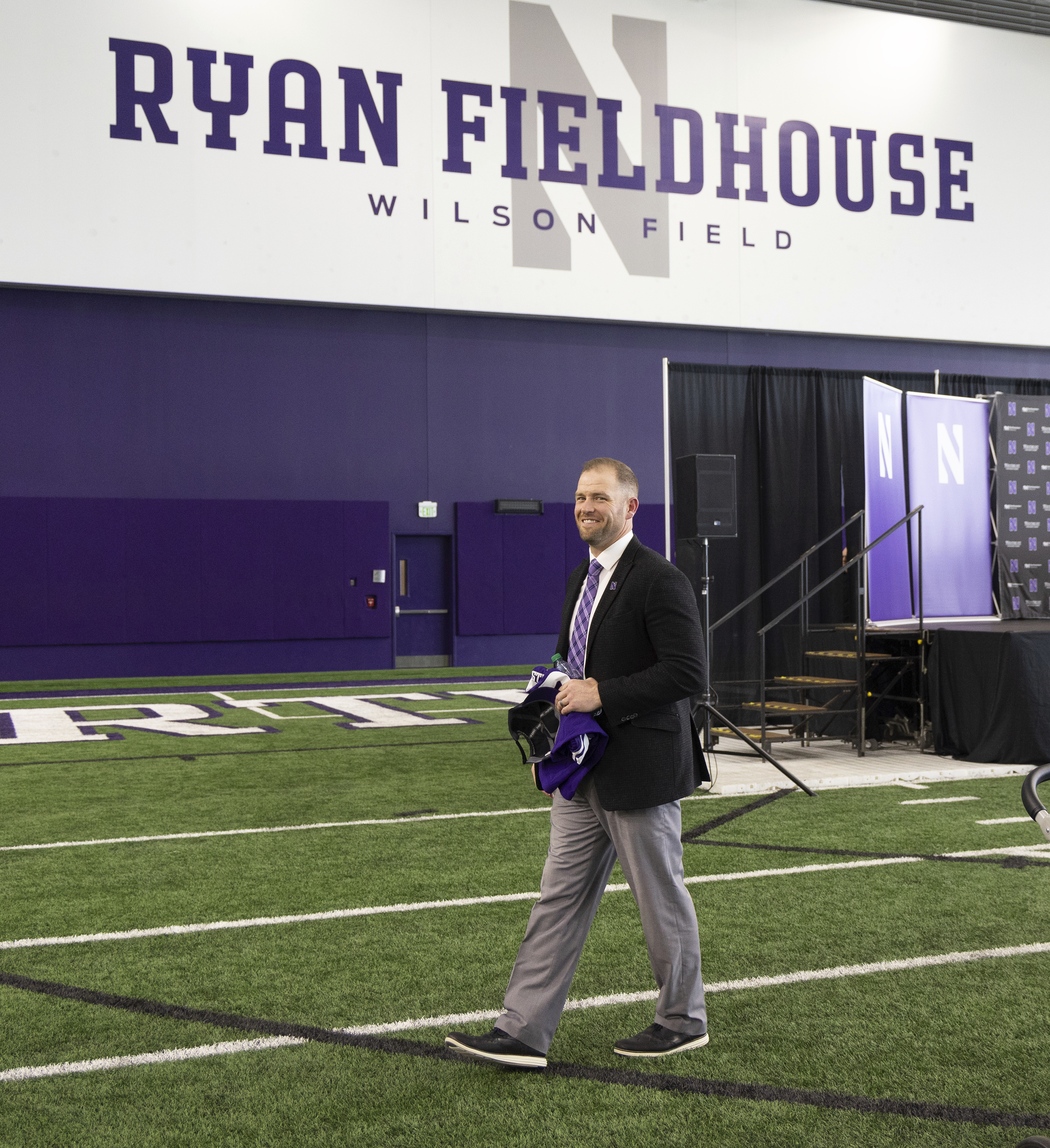 David Braun smiles after a ceremony announcing him as the official head coach of Northwestern's NCAA college football team Thursday, Nov. 16, 2023, in Evanston, Ill. Northwestern looks to become bowl eligible when it hosts Purdue in its first game since coach Braun had the interim tag removed from his job title. The school made that move on Wednesday. 