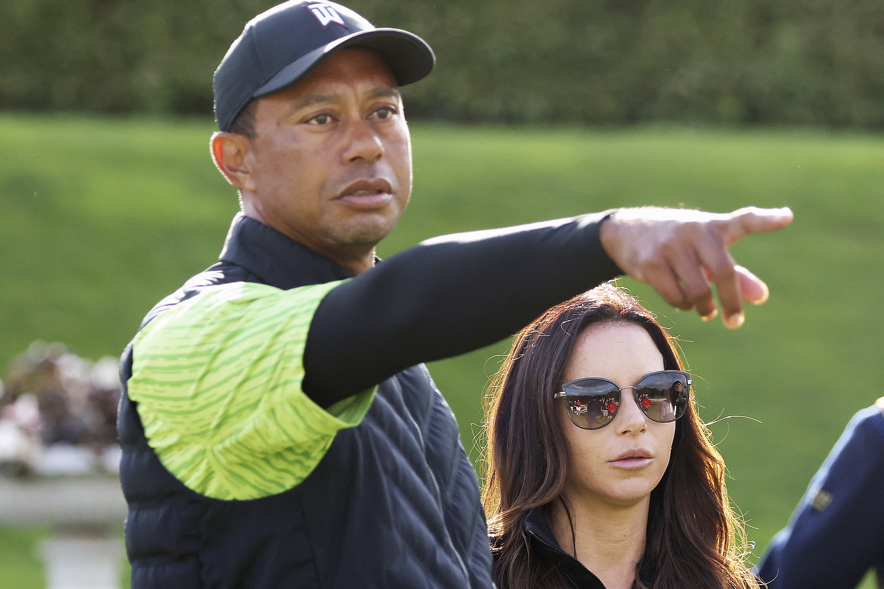 FILE - Tiger Woods, left, and Erica Herman appear on the 18th green during the JP McManus Pro-Am at Adare Manor, Limerick, Ireland, July, 4, 2022. Herman, the ex-girlfriend of golf superstar Woods, has dropped her $30 million lawsuit against the trust that owns his $54 million Florida mansion. 