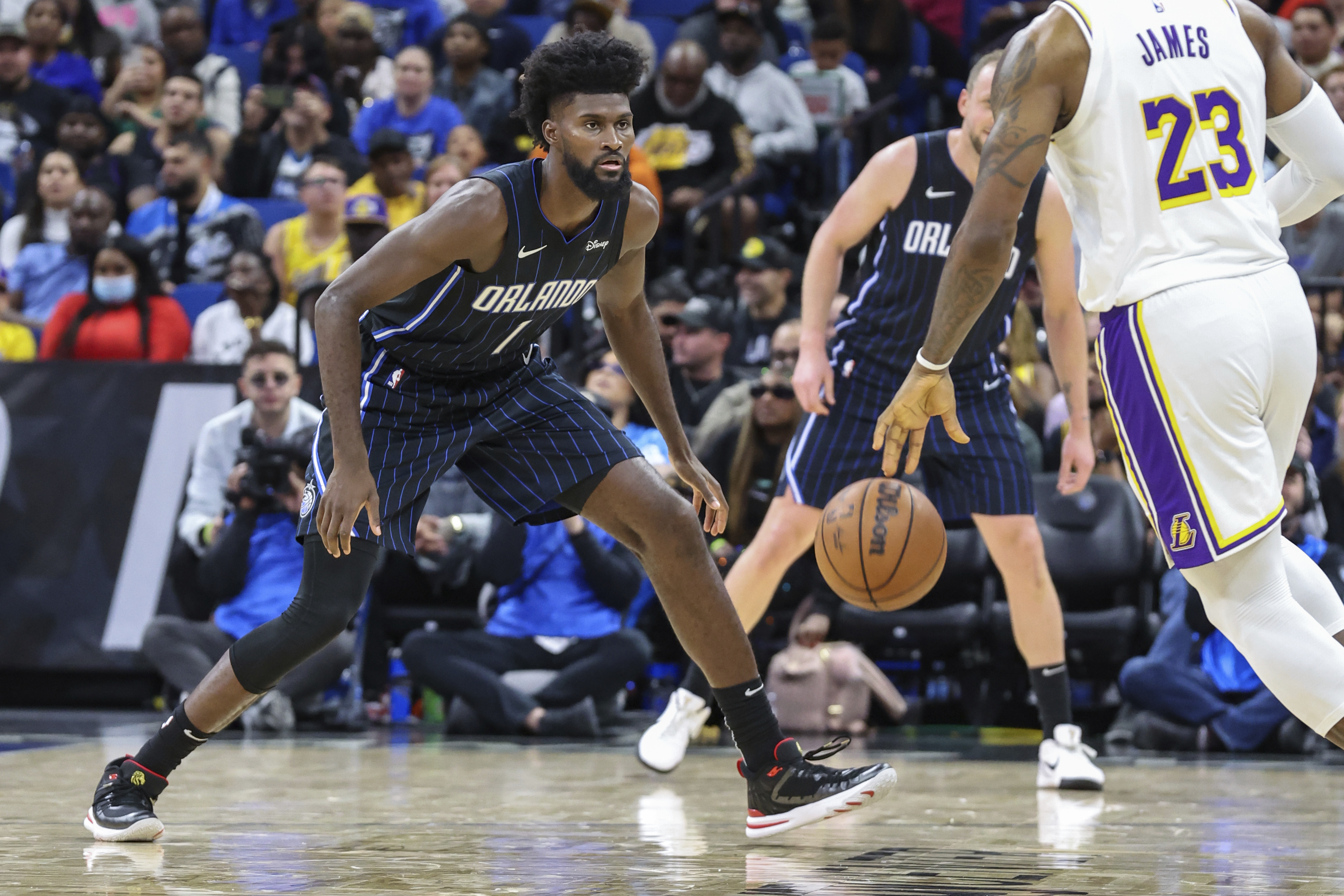Orlando Magic forward Jonathan Isaac (1) defends against Los Angeles Lakers forward LeBron James (23) during the second half of an NBA basketball game, Nov. 4, in Orlando, Fla.