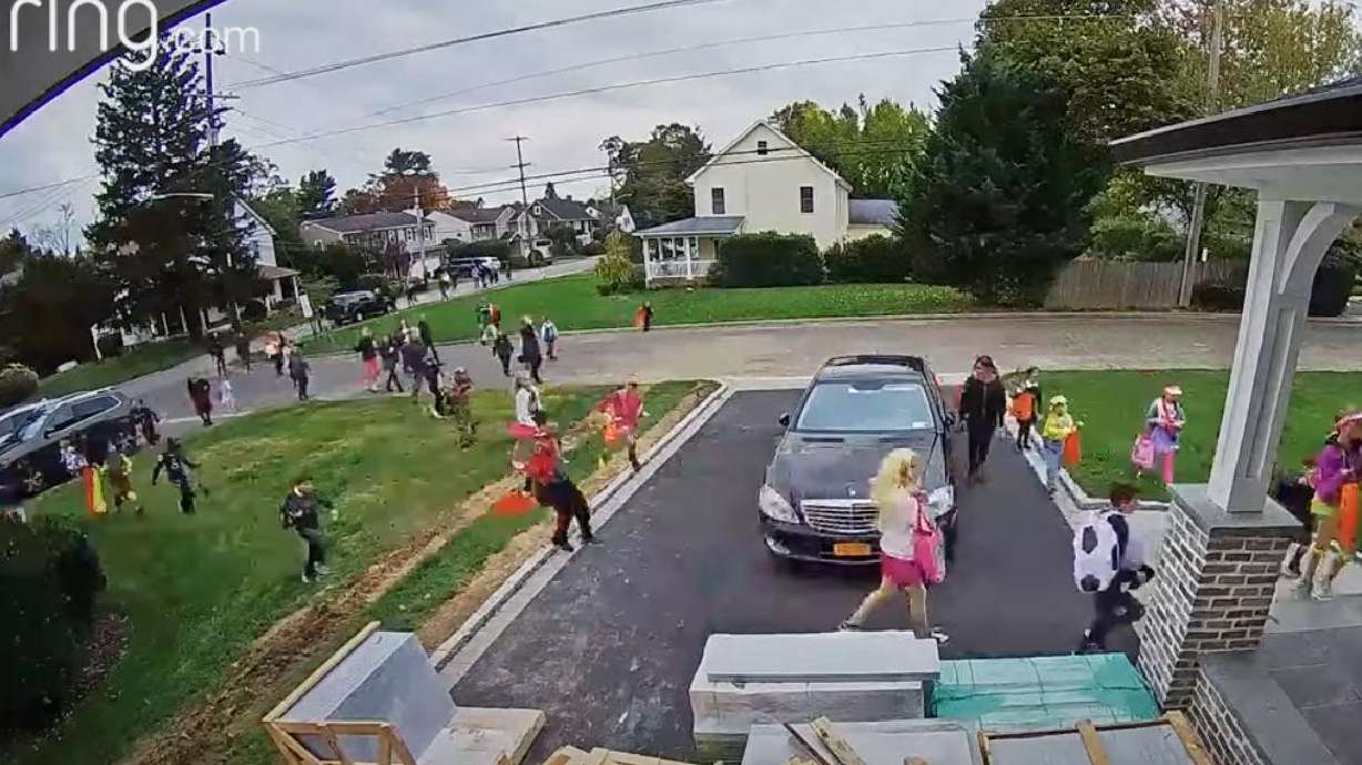 Children in costumes flock to one of the "good candy" houses in this New York neighborhood last month.
