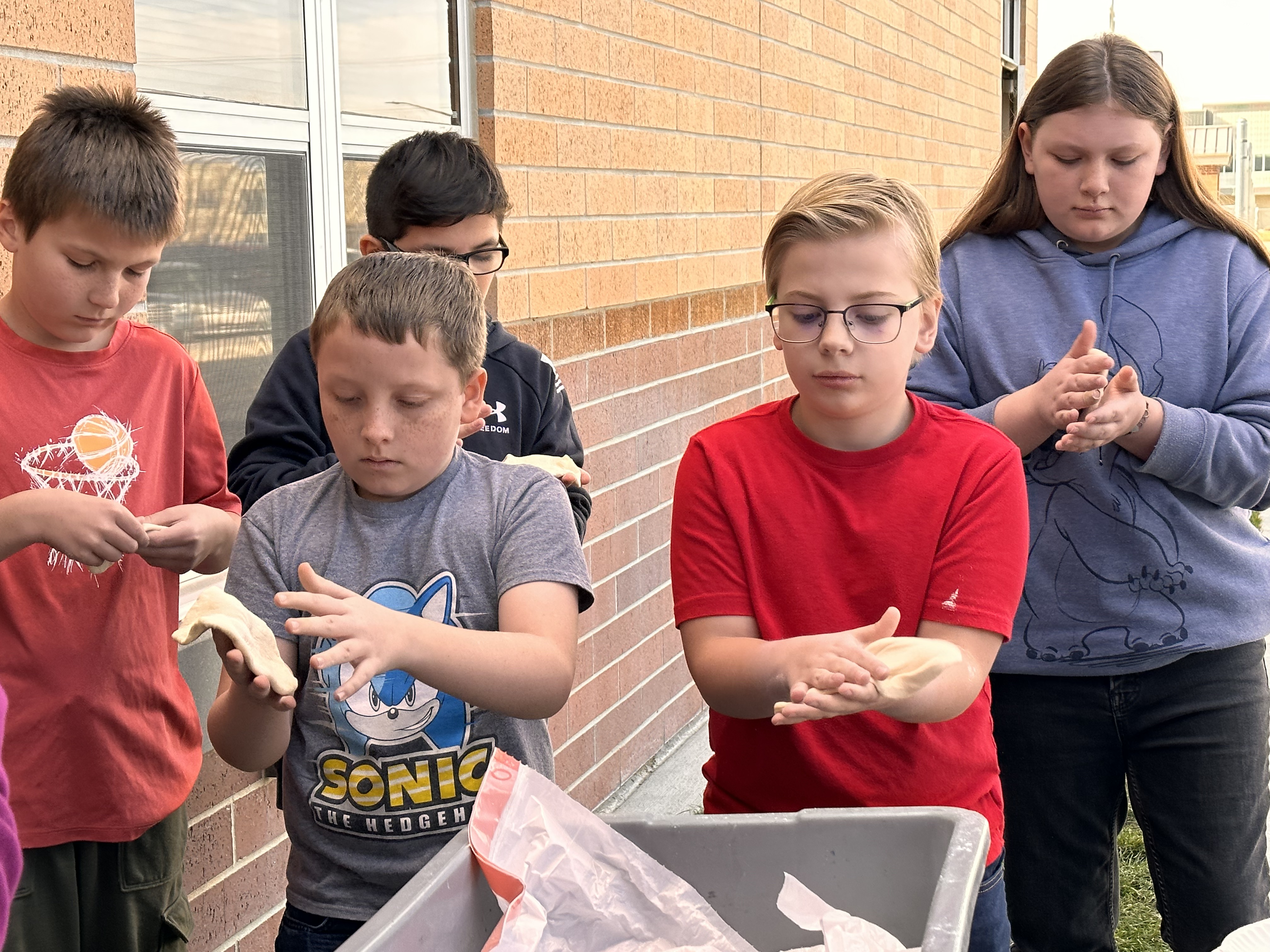 Fifth graders Brooks Morgan and Caleb Buck make their own fry bread during a lesson from the BYU Arts Partnership's Native American Curriculum Initiative at Meadow Brook Elementary School on Nov. 13.