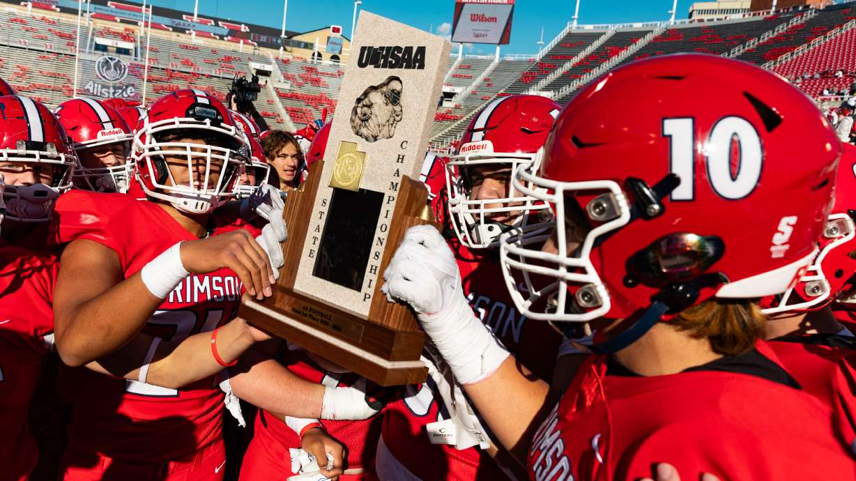 Crimson Cliffs playersl celebrates their championship win over Green Canyon for the 4A football state championship at Rice-Eccles Stadium in Salt Lake City on Friday, Nov. 17, 2023.
