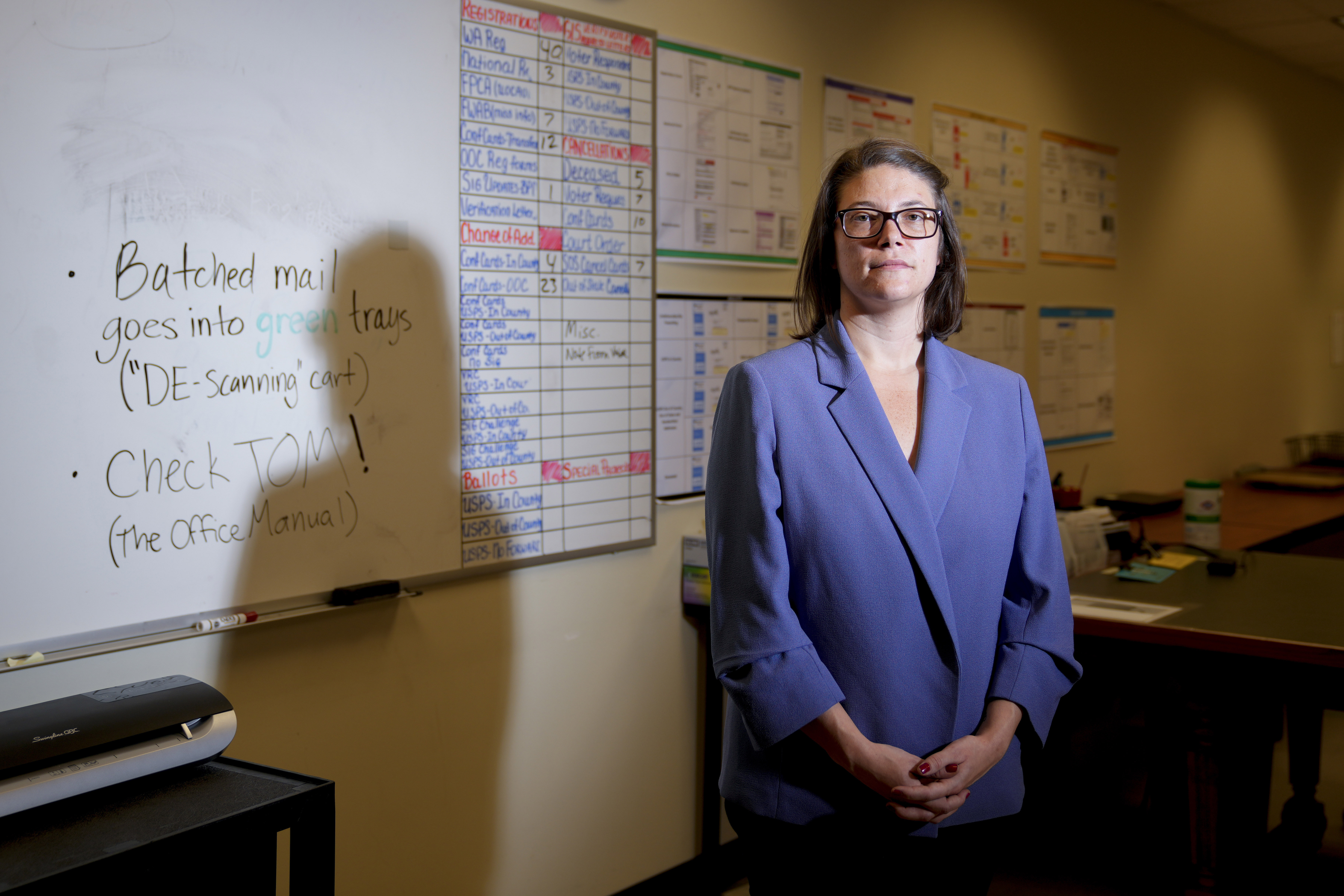 Halei Watkins, communications manager for King County Elections, is seen in the mail room on Friday, in Renton, Wash. The office began stocking Narcan, the nasal spray version of overdose-reversal drug naloxone, after receiving a letter laced with fentanyl.
