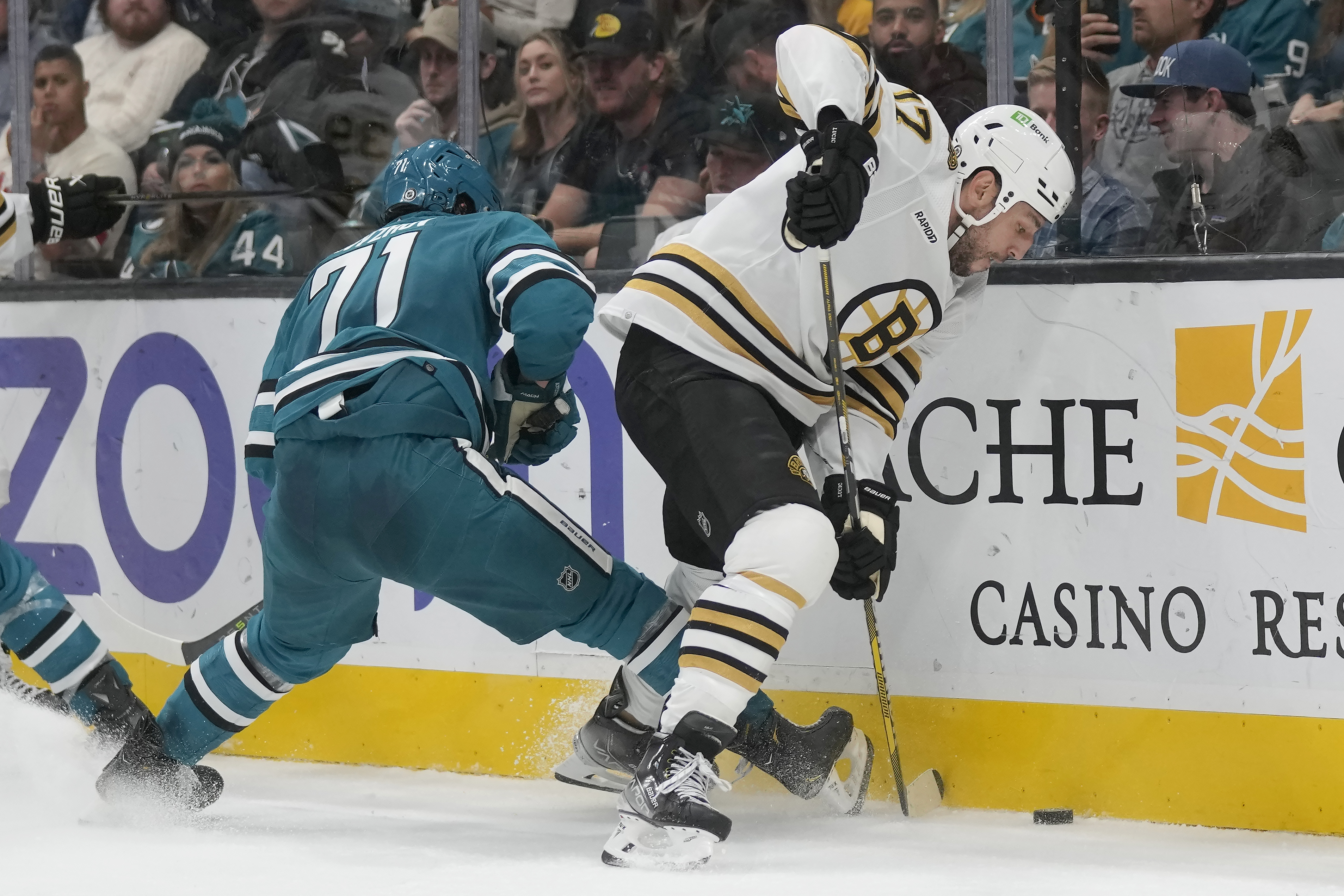Boston Bruins left wing Milan Lucic (17) reaches for the puck in front of San Jose Sharks defenseman Nikolai Knyzhov (71) during the second period of an NHL hockey game in San Jose, Calif., Thursday, Oct. 19, 2023. 