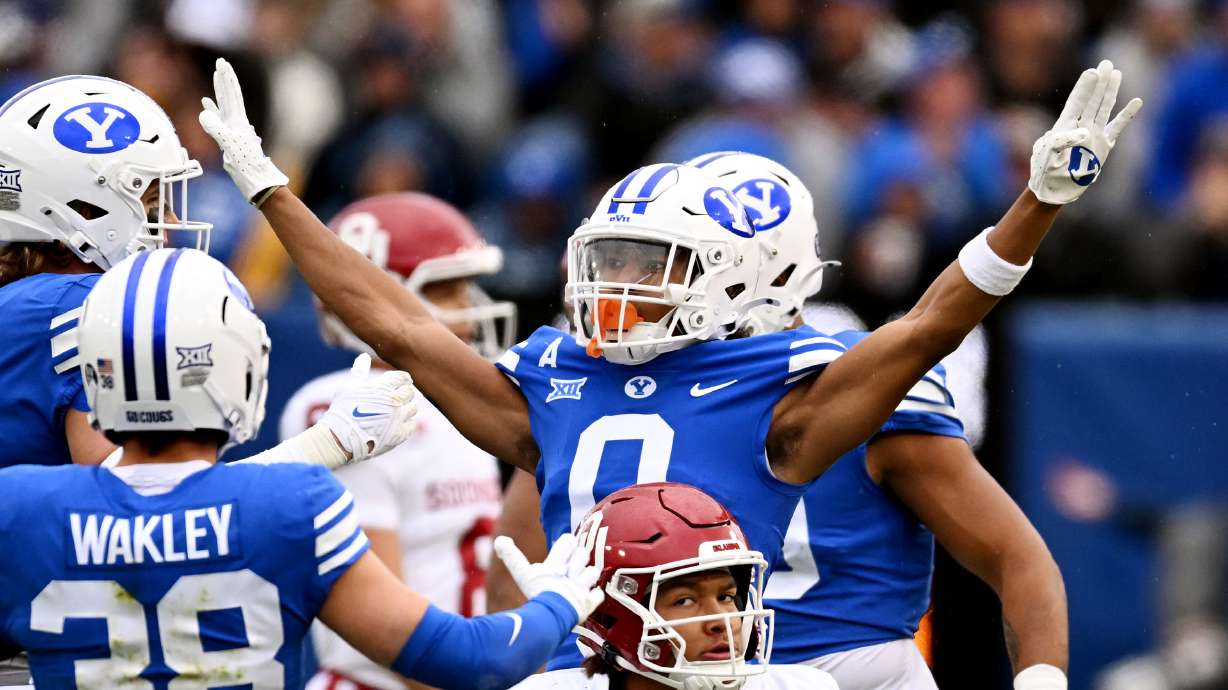 Brigham Young cornerback Jakob Robinson (0) celebrates after a defensive stop on Oklahoma wide receiver Nic Anderson (4) as BYU and Oklahoma play at LaVell Edwards Stadium in Provo on Saturday, Nov. 18, 2023.