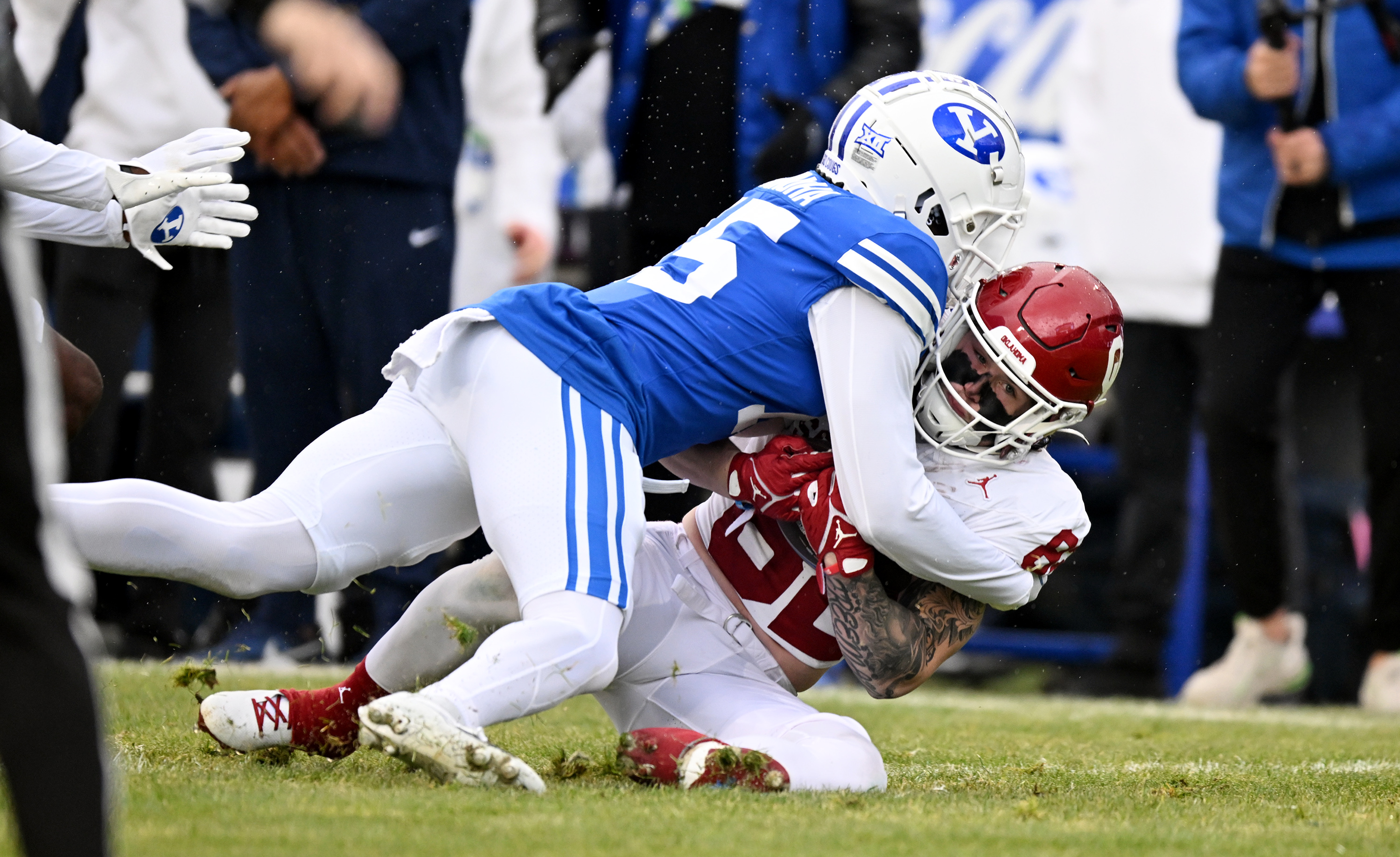 Brigham Young's Chika Ebunoha (15) hits Oklahoma wide receiver Gavin Freeman (82) immediately during punt coverage as BYU and Oklahoma play at LaVell Edwards Stadium in Provo on Saturday, Nov. 18, 2023.