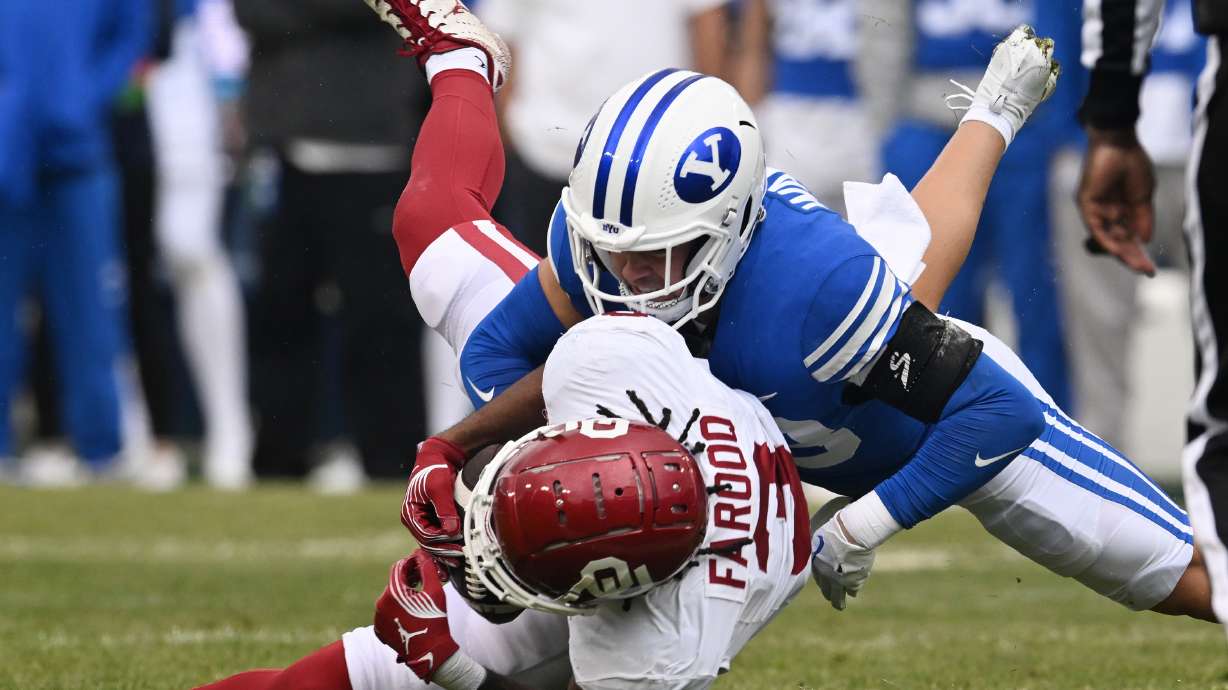 Brigham Young safety Crew Wakley (38) brings down Oklahoma wide receiver Jalil Farooq (3) as BYU and Oklahoma play at LaVell Edwards Stadium in Provo on Saturday, Nov. 18, 2023.