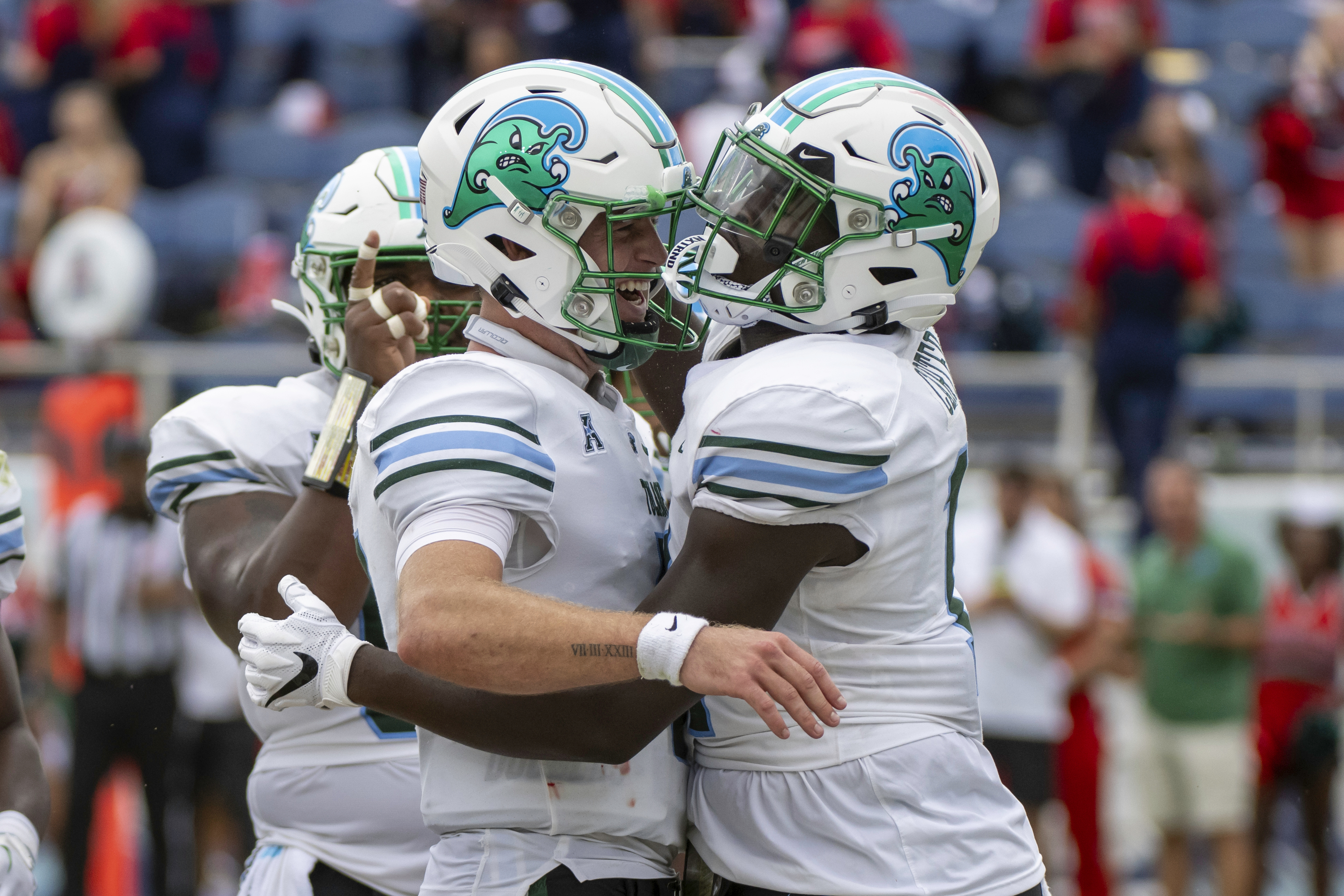 Tulane tight end Chris Carter (11) celebrates with quarterback Michael Pratt (7) after scoring a touchdown during the first half of an NCAA football game against Florida Atlantic, Saturday, Nov. 18, 2023 in Boca Raton, Fla. 