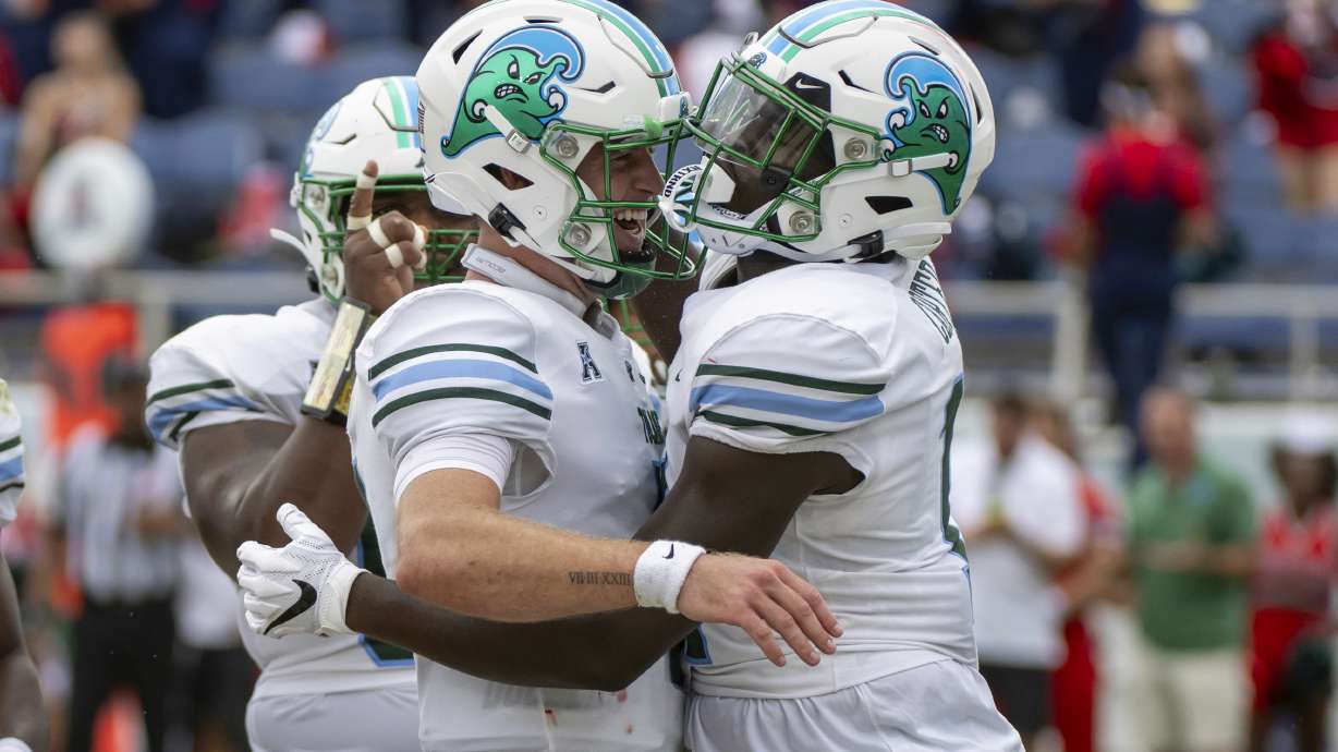 Tulane tight end Chris Carter (11) celebrates with quarterback Michael Pratt (7) after scoring a touchdown during the first half of an NCAA football game against Florida Atlantic, Saturday, Nov. 18, 2023 in Boca Raton, Fla.