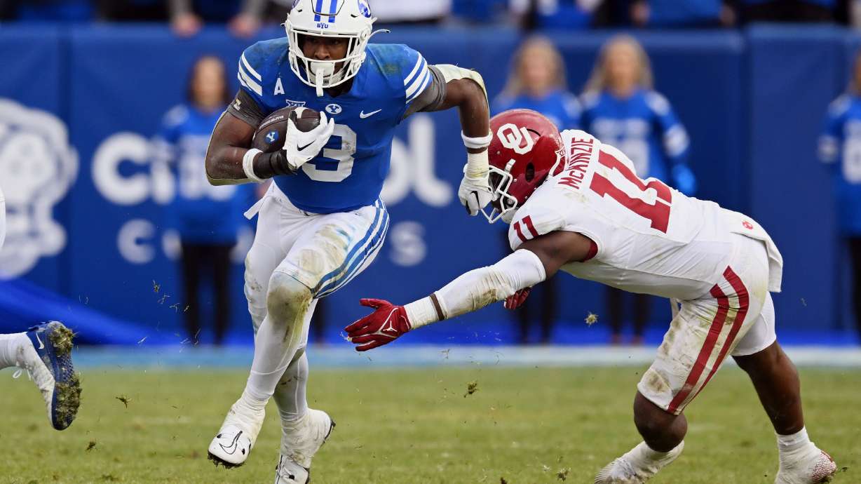Brigham Young running back Aidan Robbins (3) brakes away for a long run ahead of Oklahoma Sooners linebacker Kobie McKinzie (11) as BYU and Oklahoma play at LaVell Edwards stadium in Provo on Saturday, Nov. 18, 2023. OU won 31-24.