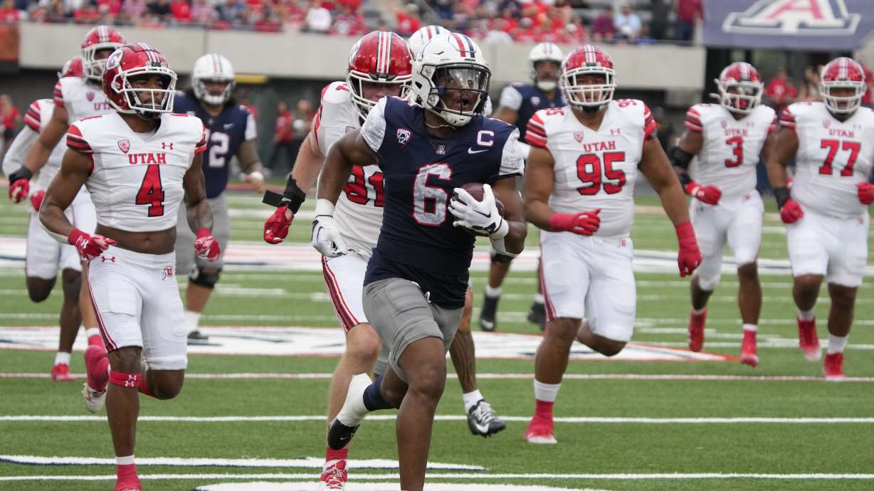 Arizona running back Michael Wiley (6) scores a touchdown against Utah during the first half of an NCAA college football game, Saturday, Nov. 18, 2023, in Tucson, Ariz.