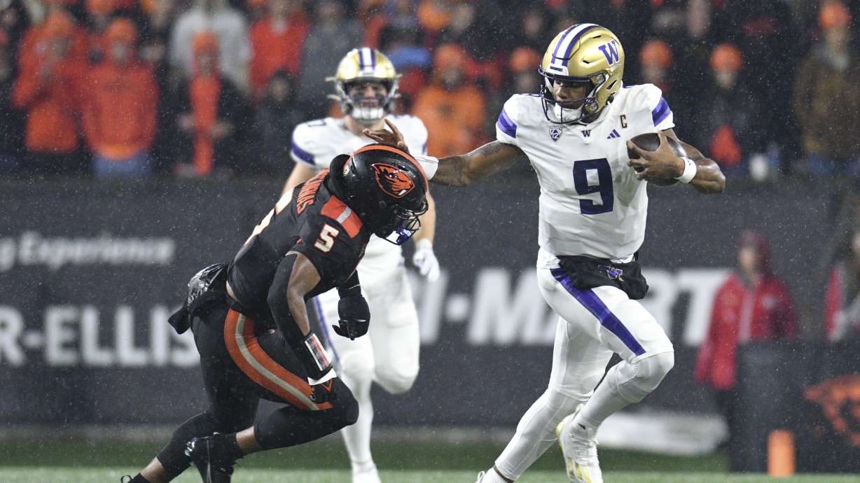 Washington quarterback Michael Penix Jr. (9) dodges Oregon State linebacker Easton Mascarenas-Arnold (5) during the first half of an NCAA college football game Saturday, Nov. 18, 2023, in Corvallis, Ore.