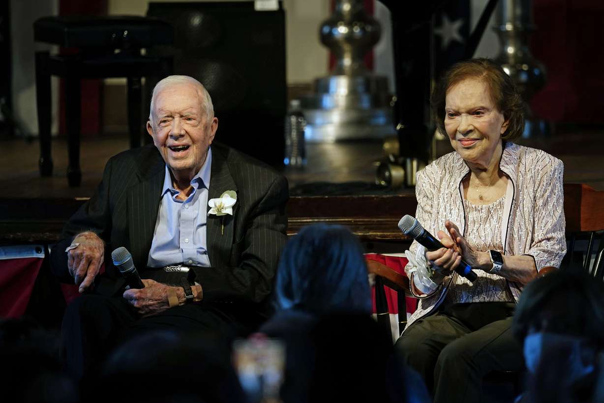 Former U.S. President Jimmy Carter and his wife, former first lady Rosalynn Carter, sit together during a reception to celebrate their 75th wedding anniversary, July 10, 2021, in Plains, Ga. Rosalynn Carter died Sunday at 96.