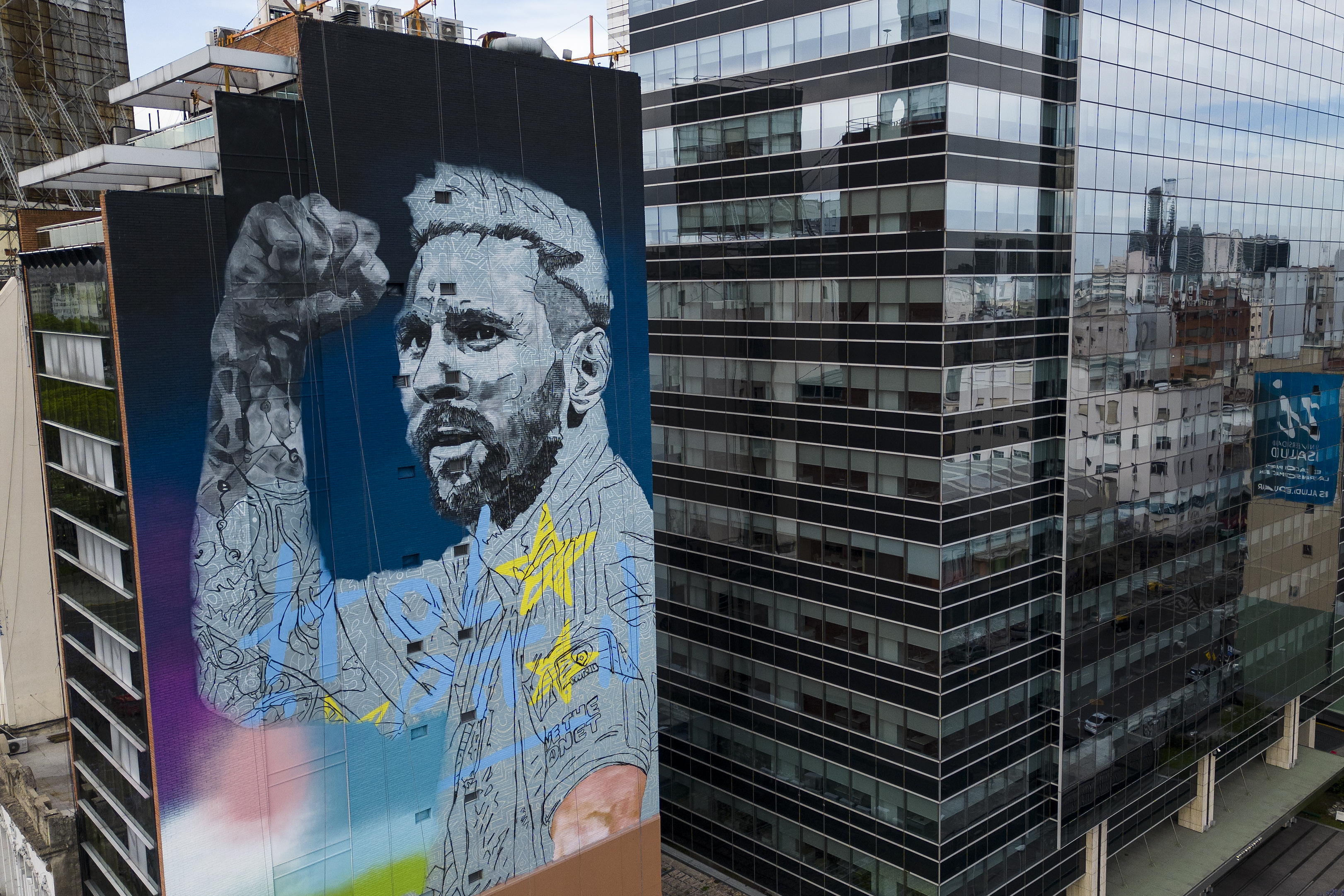 A mural depicting soccer legend Lionel Messi, by artist Martin Ron, adorns a building on the 9 de Julio avenue in Buenos Aires, Argentina, Saturday, Nov. 18, 2023. 