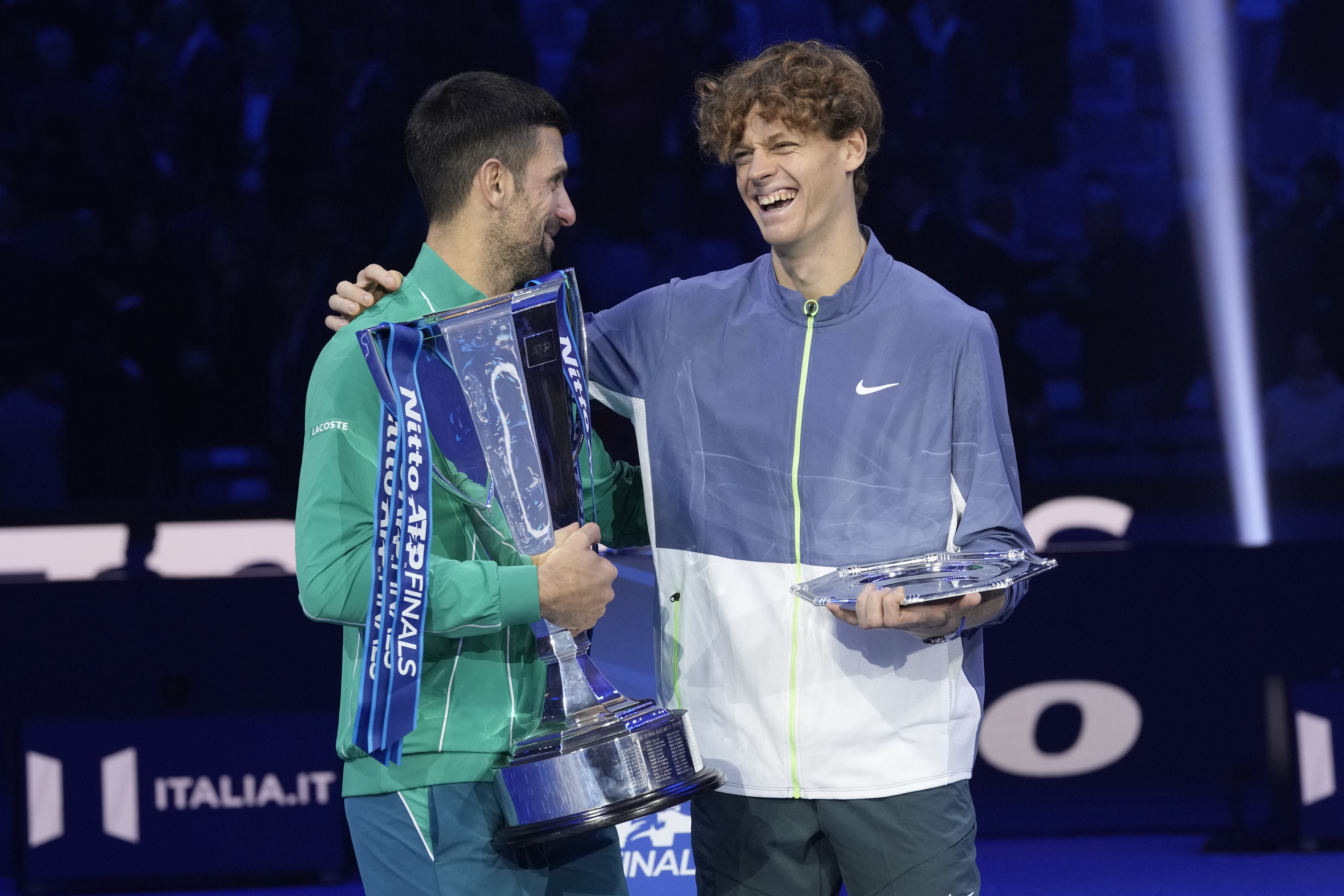Serbia's Novak Djokovic, winner, left, and second placed Italy's Jannik Sinner hold their trophies at the end of the singles final tennis match of the ATP World Tour Finals at the Pala Alpitour, in Turin, Italy, Sunday, Nov. 19, 2023.
