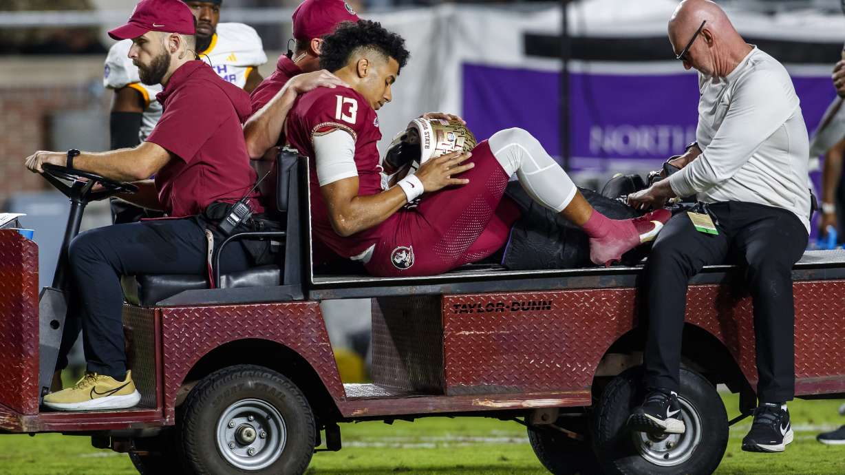 Florida State quarterback Jordan Travis is taken off the field after being injured during the first half of the team's NCAA college football game against North Alabama, Saturday, Nov. 18, 2023, in Tallahassee, Fla.