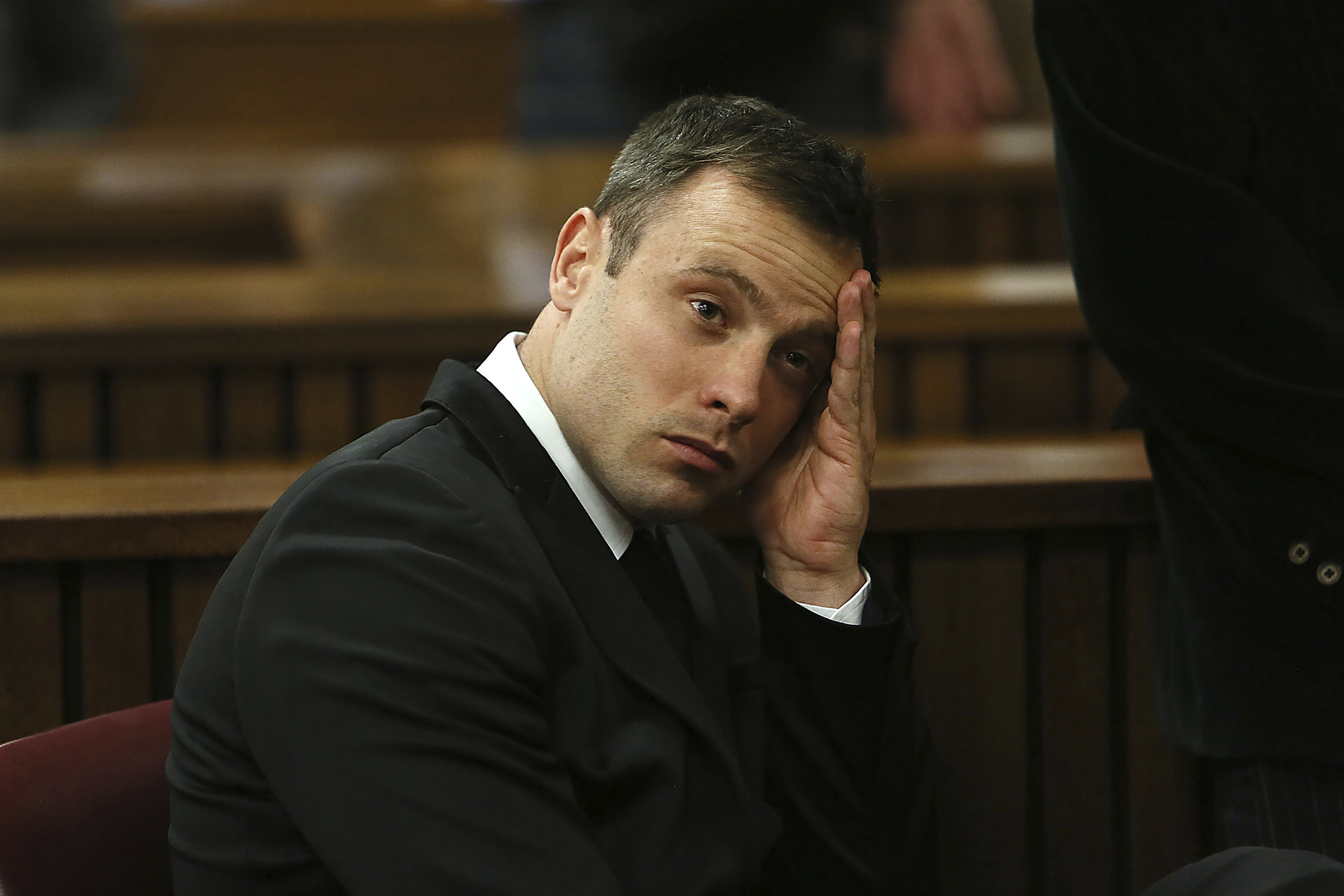 FILE - Oscar Pistorius gestures, at the end of the fourth day of sentencing proceedings in the high court in Pretoria, South Africa, Thursday, Oct. 16, 2014. Pistorius will have a second chance at parole at a hearing on Friday, Nov. 24, 2023 after he was wrongly ruled ineligible for early release from jail in March. South Africa’s department of corrections said in a statement on Monday, Nov. 20 that a parole board will consider the former Olympic runner’s case again this week. Pistorius turns 37 on Wednesday and has been in prison for nearly a decade. 