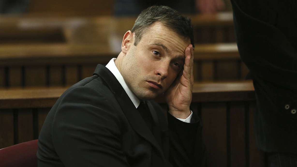 FILE - Oscar Pistorius gestures, at the end of the fourth day of sentencing proceedings in the high court in Pretoria, South Africa, Thursday, Oct. 16, 2014. Pistorius will have a second chance at parole at a hearing on Friday, Nov. 24, 2023 after he was wrongly ruled ineligible for early release from jail in March. South Africa’s department of corrections said in a statement on Monday, Nov. 20 that a parole board will consider the former Olympic runner’s case again this week. Pistorius turns 37 on Wednesday and has been in prison for nearly a decade.
