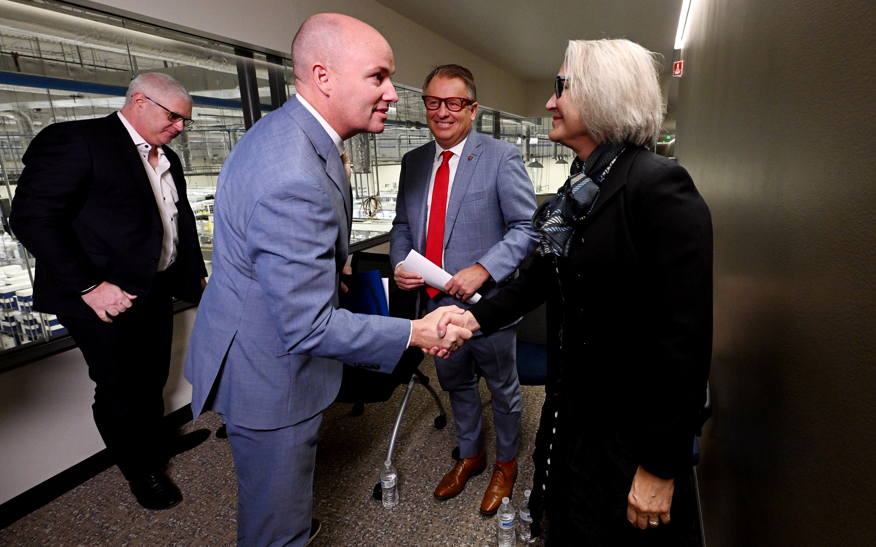 Gov. Spencer J. Cox shakes talks with President Elizabeth Cantwell, Utah State University and President Taylor Randall, University of Utah after a press conference at bioMérieux in Salt Lake City, announcing a proposal aimed at supporting Utah’s life sciences workforce on Monday.