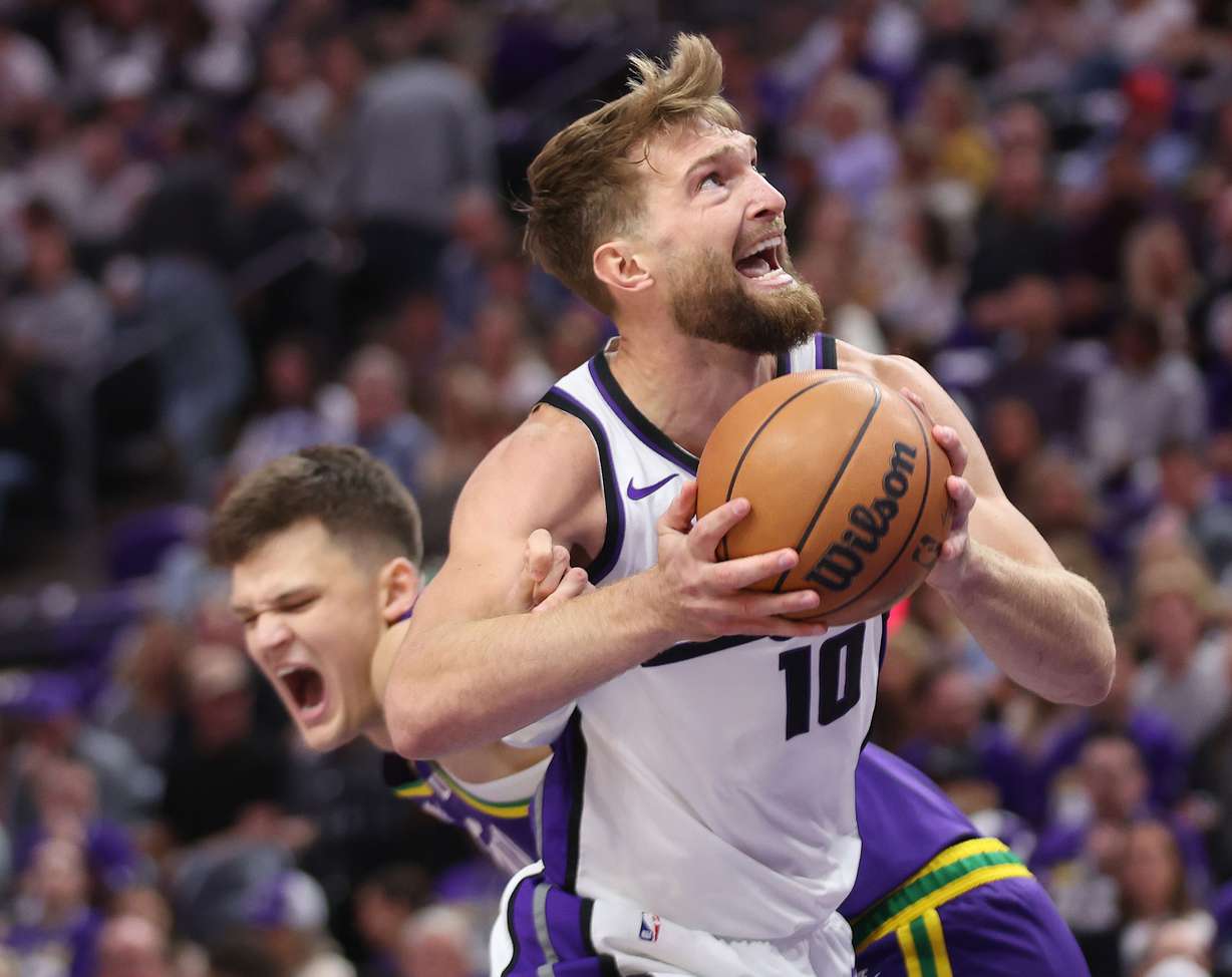 Sacramento Kings forward Domantas Sabonis (10) gets tangled up with Utah Jazz center Walker Kessler (24) in Salt Lake City on Wednesday, Oct. 25, 2023. The Kings won 130-114.