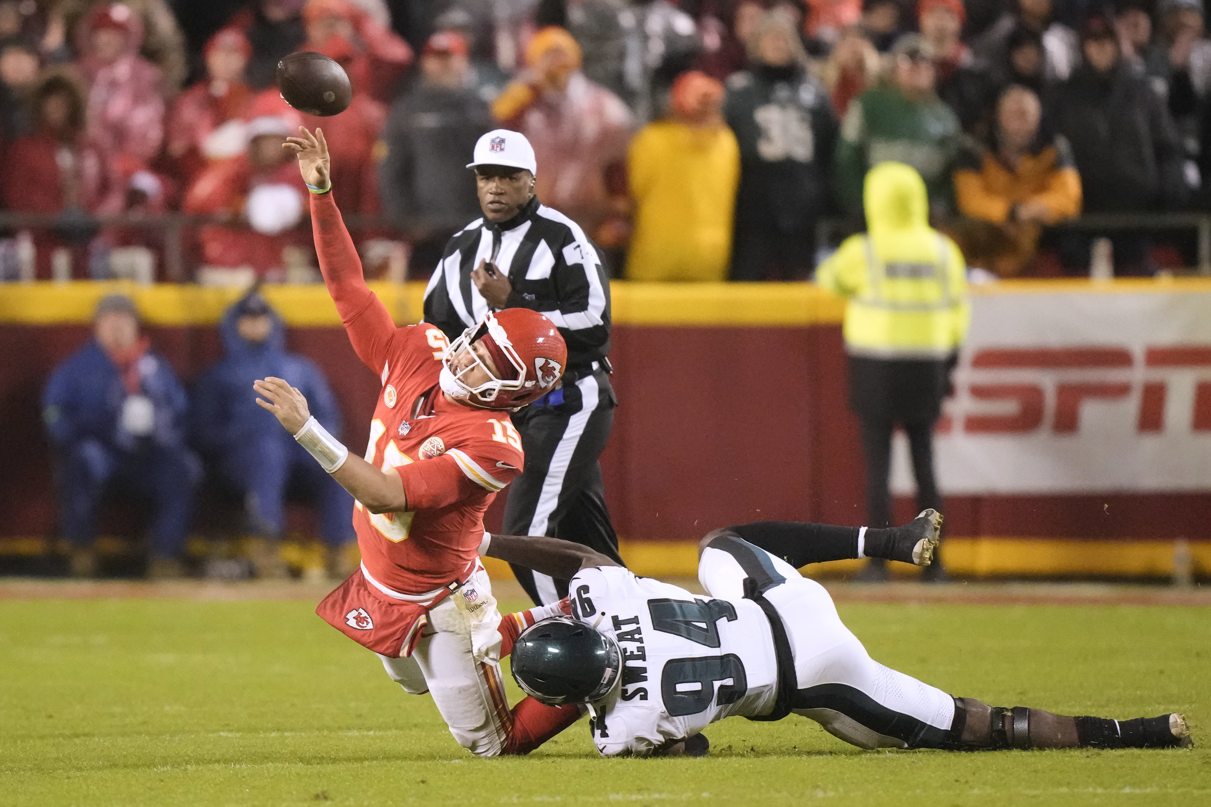 Kansas City Chiefs quarterback Patrick Mahomes, left, throws under pressure from Philadelphia Eagles defensive end Josh Sweat (94) during the second half of an NFL football game, Monday, Nov. 20, 2023, in Kansas City, Mo. Mahomes was charged with intentional grounding on the play. 