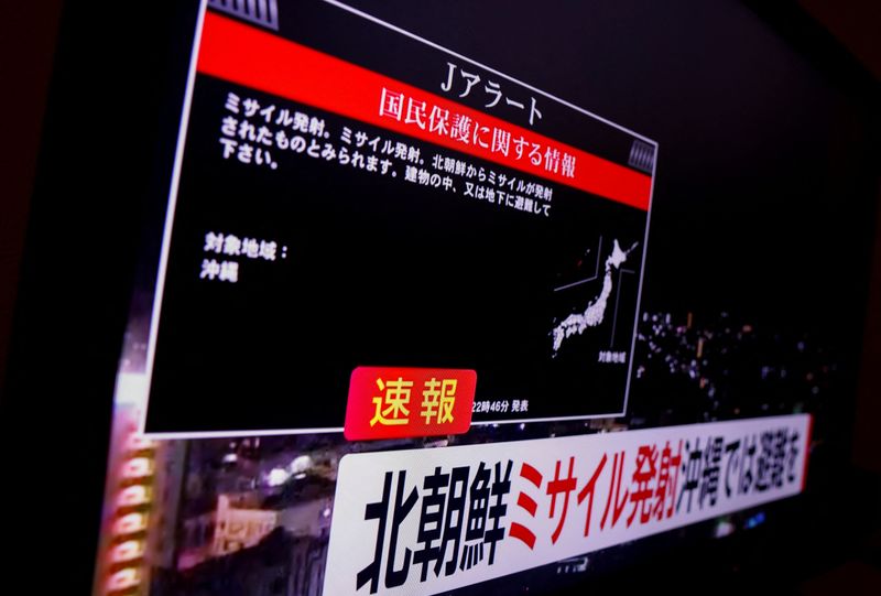 A TV screen displays a warning message called "J-alert" after the Japanese government issued an emergency warning for residents of the southern prefecture of Okinawa, saying a missile had been launched from North Korea and that residents of Okinawa prefecture should take cover indoors, in Tokyo, Japan Tuesday.