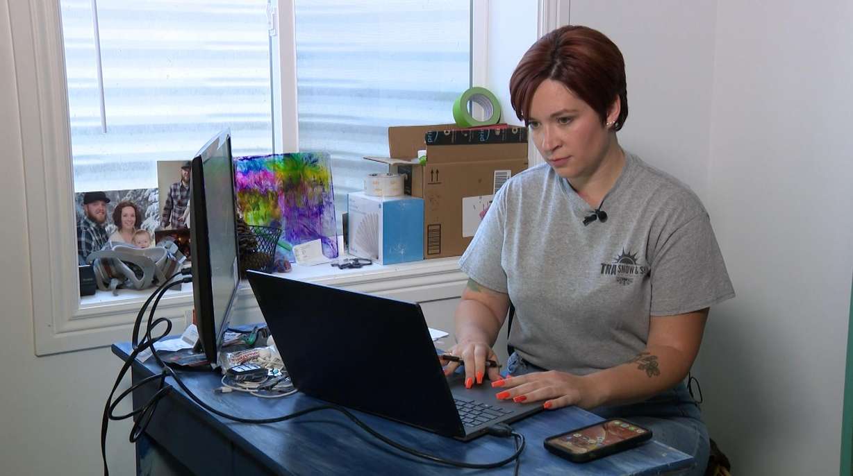 Mindy Dahlquist works on her computer. The majority of Americans, especially women, feel overwhelmed by group texts.