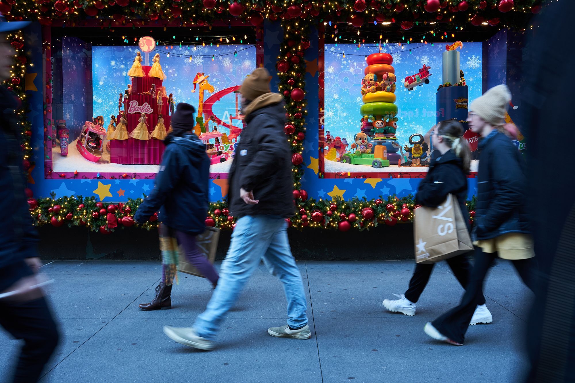 Macy's will be closed on Thanksgiving Day. Shoppers walk past holiday window displays at the Macy's flagship store in the Herald Square area of New York, on Nov. 13.