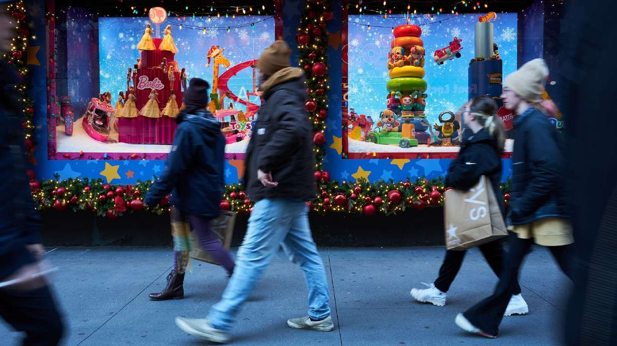 Macy's will be closed on Thanksgiving Day. Shoppers walk past holiday window displays at the Macy's flagship store in the Herald Square area of New York, on Nov. 13.