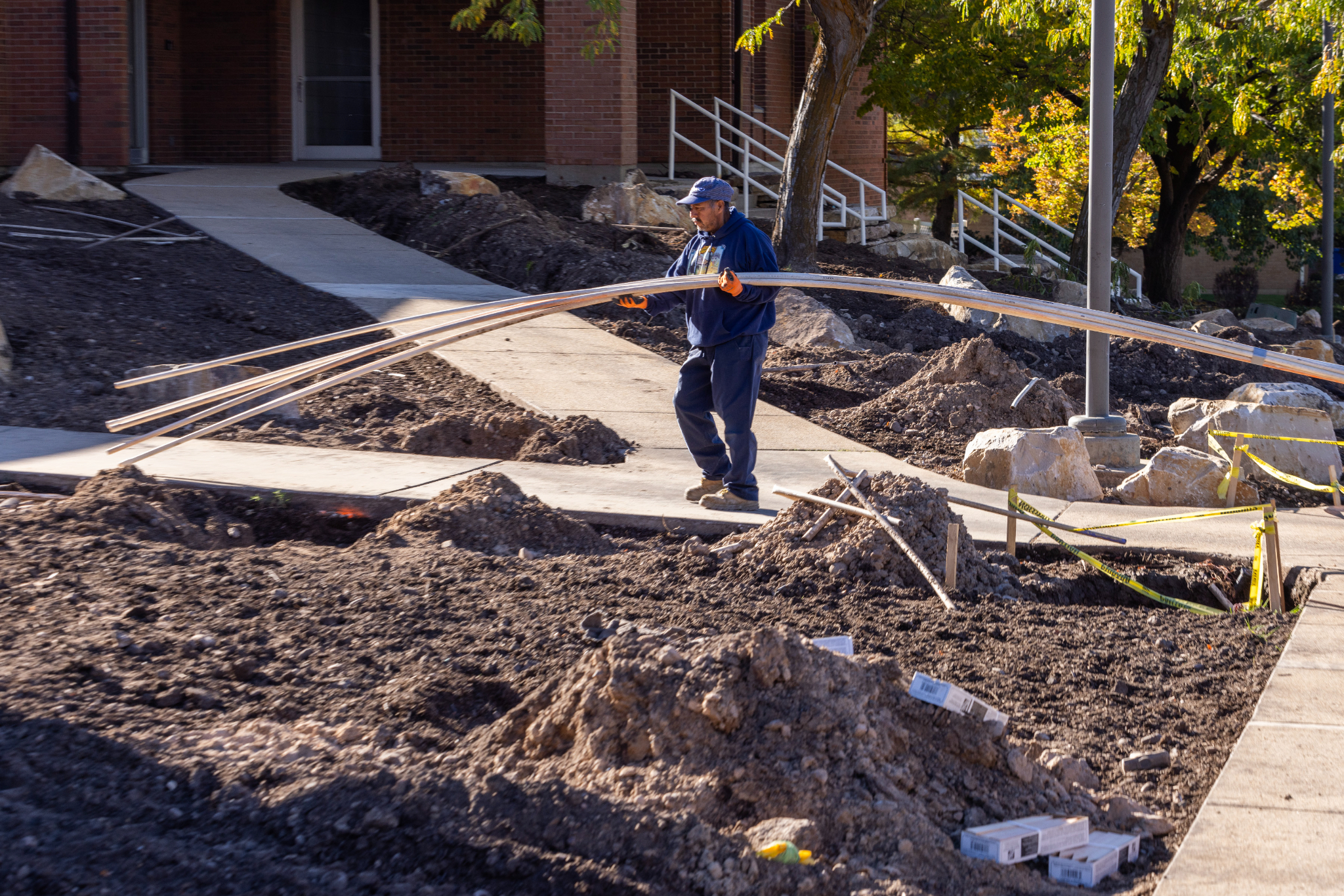 A worker outside a Utah meetinghouse of The Church of Jesus Christ of Latter-day Saints in October. The church is testing out new water-wise landscapes outside seven meetinghouses in the state.