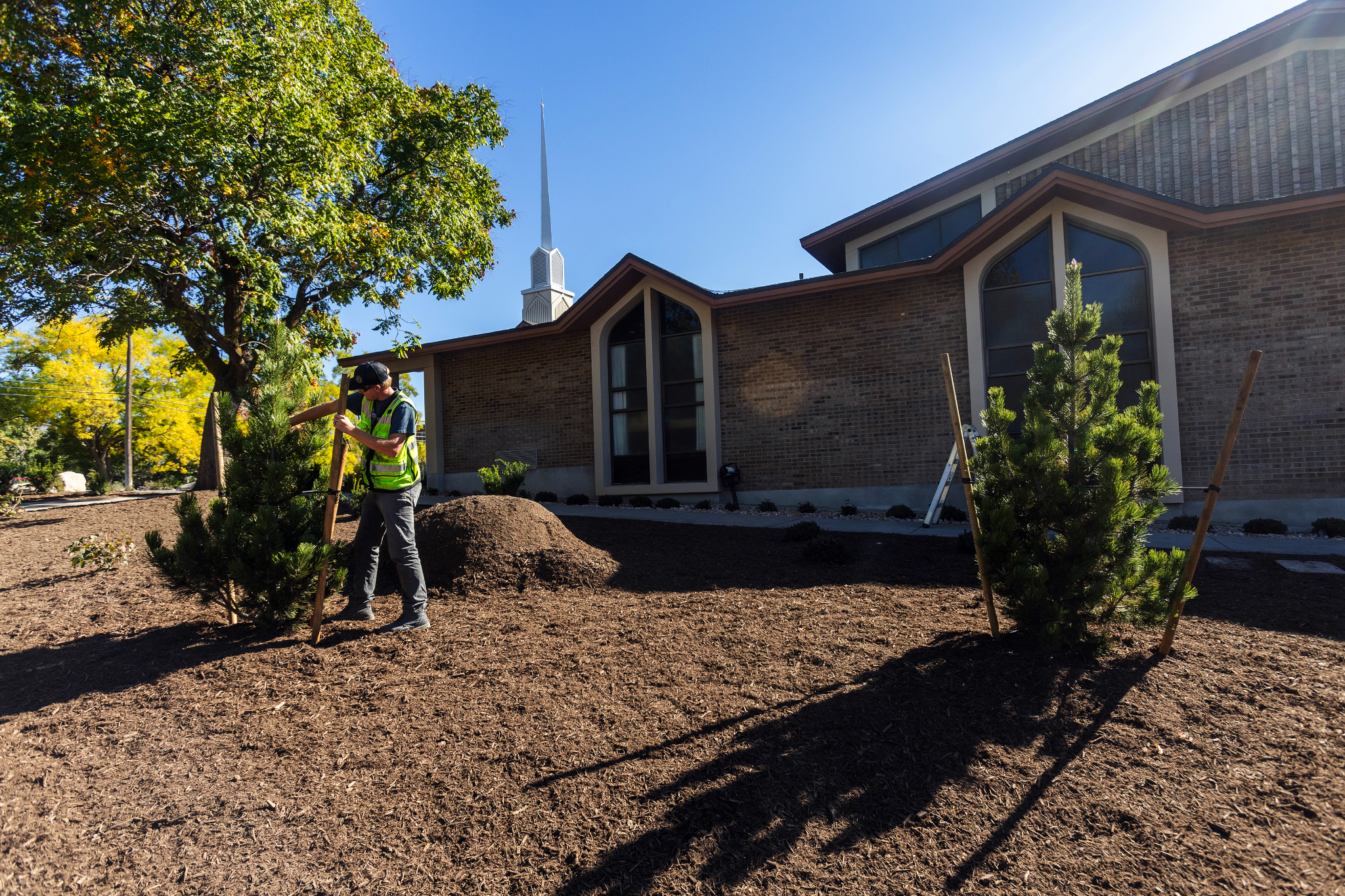 A landscaping worker plants a tree outside of a Utah meetinghouse for The Church of Jesus Christ of Latter-day Saints in October. The church says it is testing out new water-wise landscapes outside seven meetinghouses in the state.