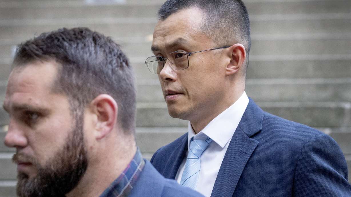 Binance founder and CEO Changpeng Zhao, right, leaves federal court in Seattle, Tuesday, after pleading guilty to violations of U.S. anti-money laundering laws.