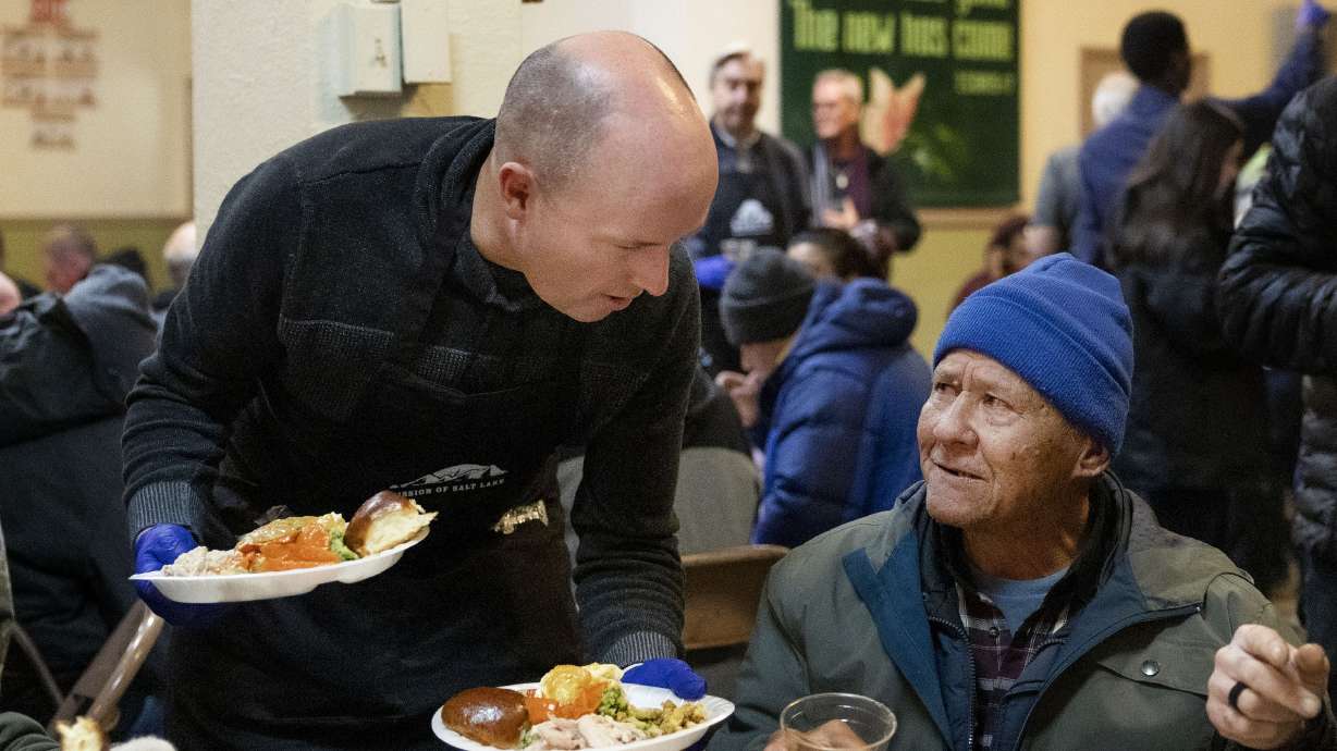 Gov. Spencer Cox serves Thanksgiving meals at the Rescue Mission in Salt Lake City on Wednesday.