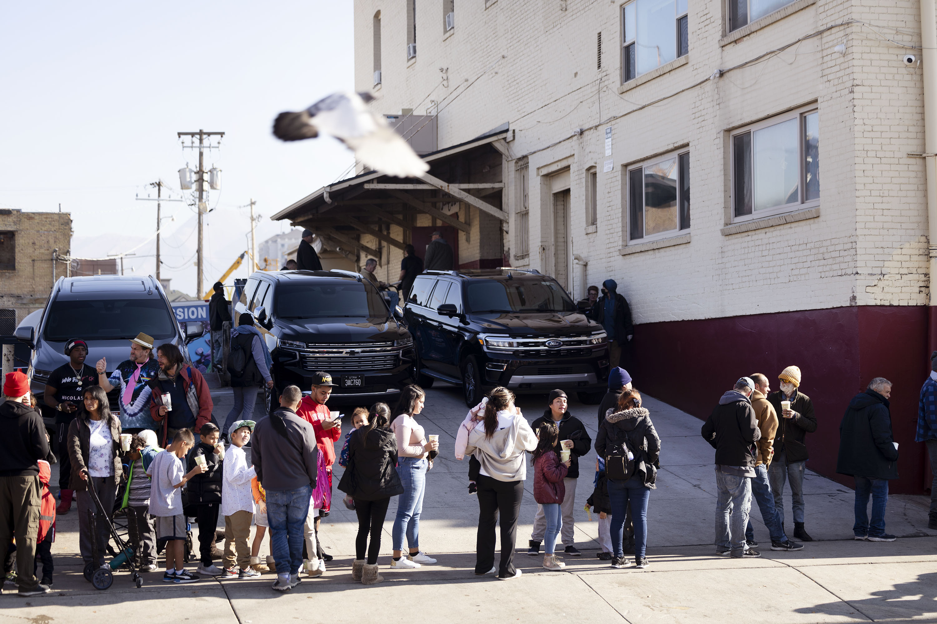 People wait for a Thanksgiving meal at the Rescue Mission in Salt Lake City on Wednesday. Following a tradition that he has upheld for over 10 years, Utah Gov. Spencer Cox and his family took some time Wednesday to serve Thanksgiving meals to Salt Lake City's homeless population.