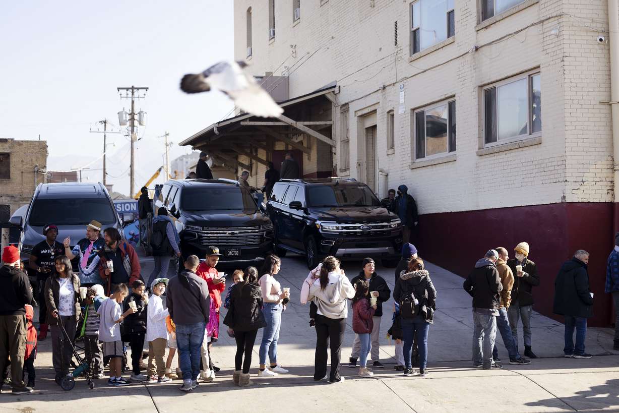 People wait for a Thanksgiving meal at the Rescue Mission in Salt Lake City on Wednesday. Following a tradition that he has upheld for over 10 years, Utah Gov. Spencer Cox and his family took some time Wednesday to serve Thanksgiving meals to Salt Lake City's homeless population.