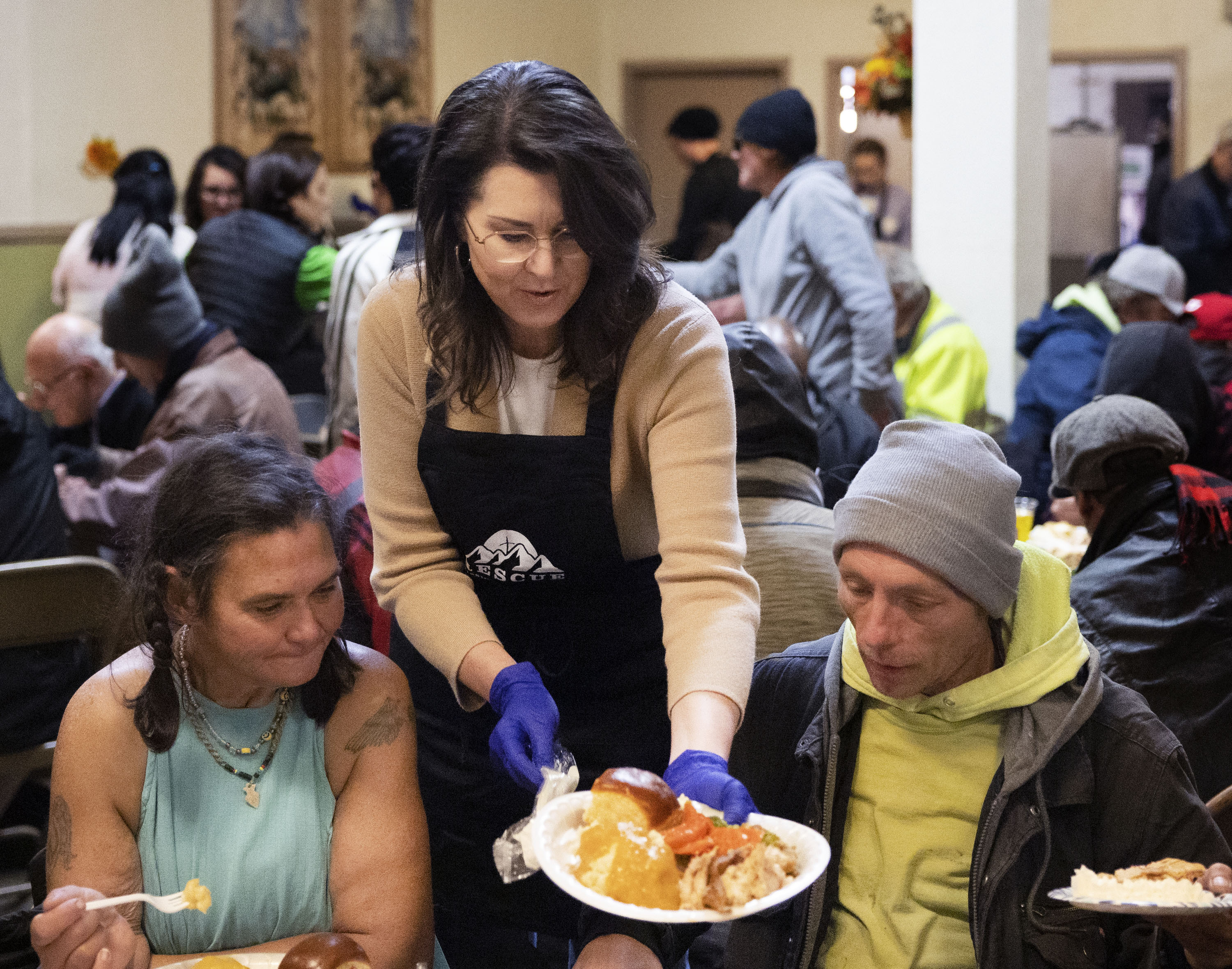 Lt. Gov. Deidre M. Henderson serves Thanksgiving meals at the Rescue Mission in Salt Lake City on Wednesday.