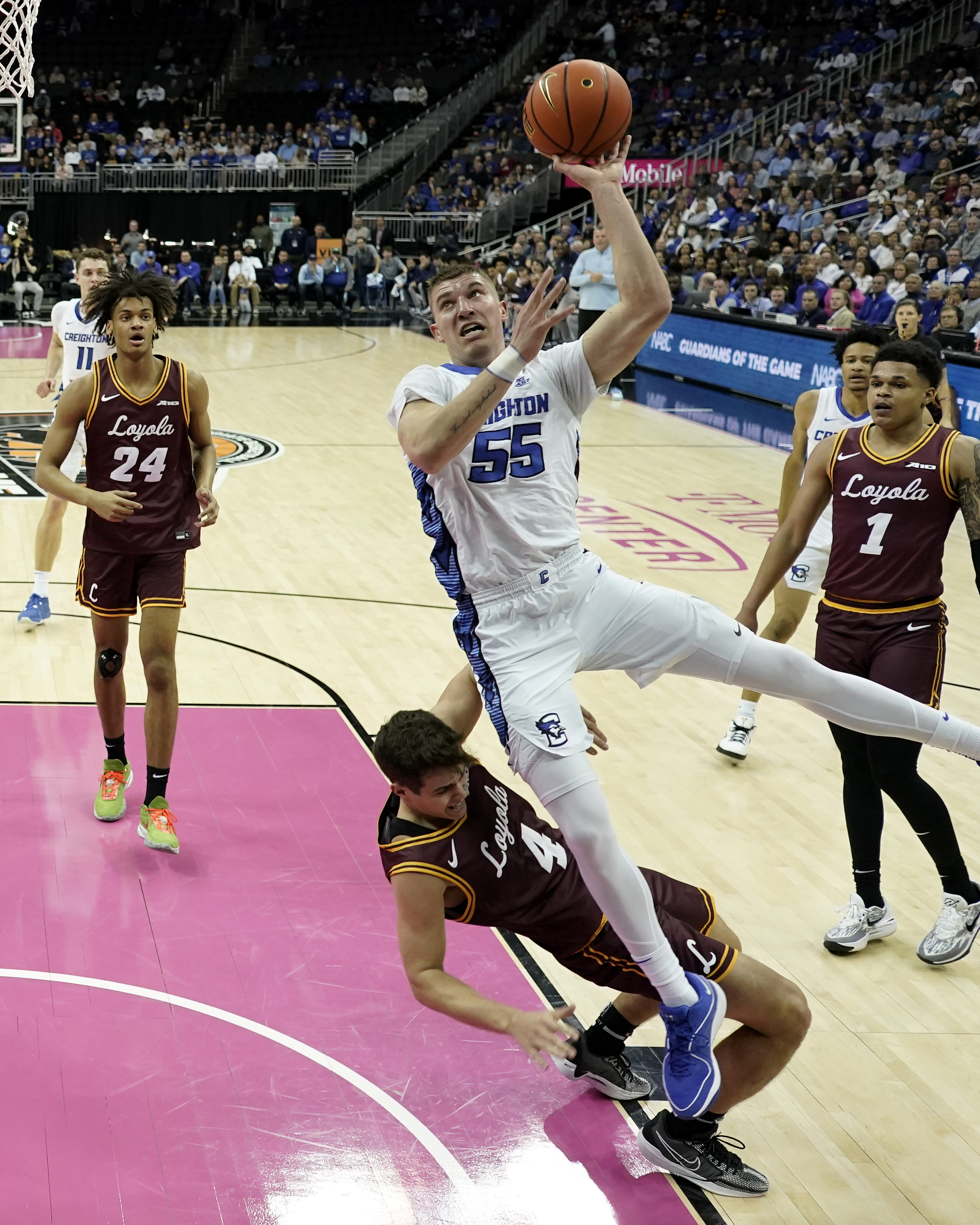 Creighton guard Baylor Scheierman (55) gets past Loyola Chicago guard Braden Norris (4) to put up a shot during the first half of an NCAA college basketball game Wednesday, Nov. 22, 2023, in Kansas City, Mo. 