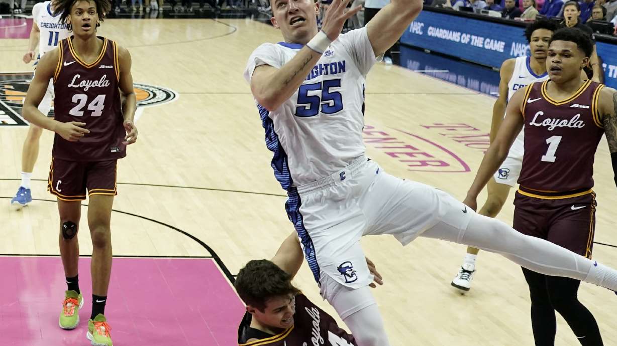 Creighton guard Baylor Scheierman (55) gets past Loyola Chicago guard Braden Norris (4) to put up a shot during the first half of an NCAA college basketball game Wednesday, Nov. 22, 2023, in Kansas City, Mo.