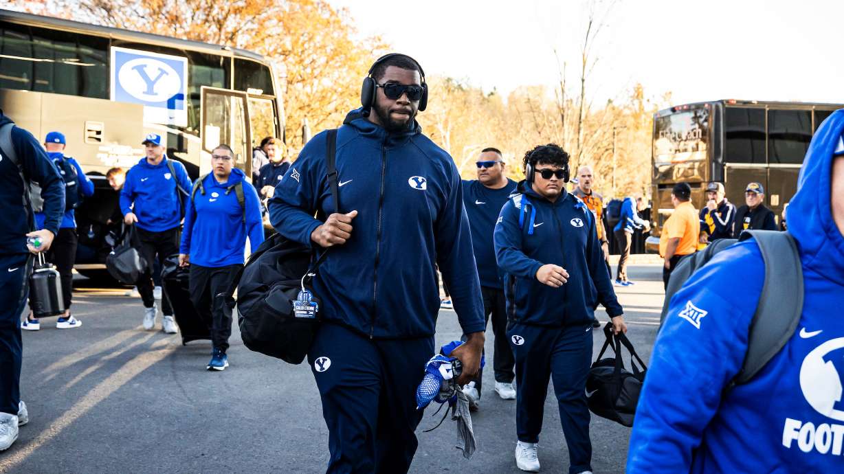 BYU offensive lineman Caleb Etienne walks into the stadium before a 37-7 loss to West Virginia, Nov. 4, 2023 in Morgantown, W.Va.