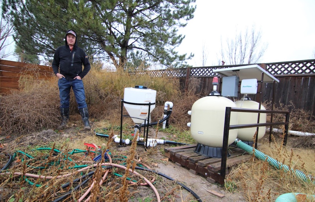 Kelby Johnson stands next to a sand filtration system for drip irrigation on his 100-acre farm in Benson on Nov. 16, 2023. A bill tied to agriculture water optimization was passed Wednesday, another another advanced through a committee.